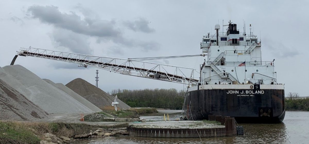 John J Boland discharging cargo from its port side using its self-unloading boom in Lorain, Ohio, after the grounding. (Source: NTSB)