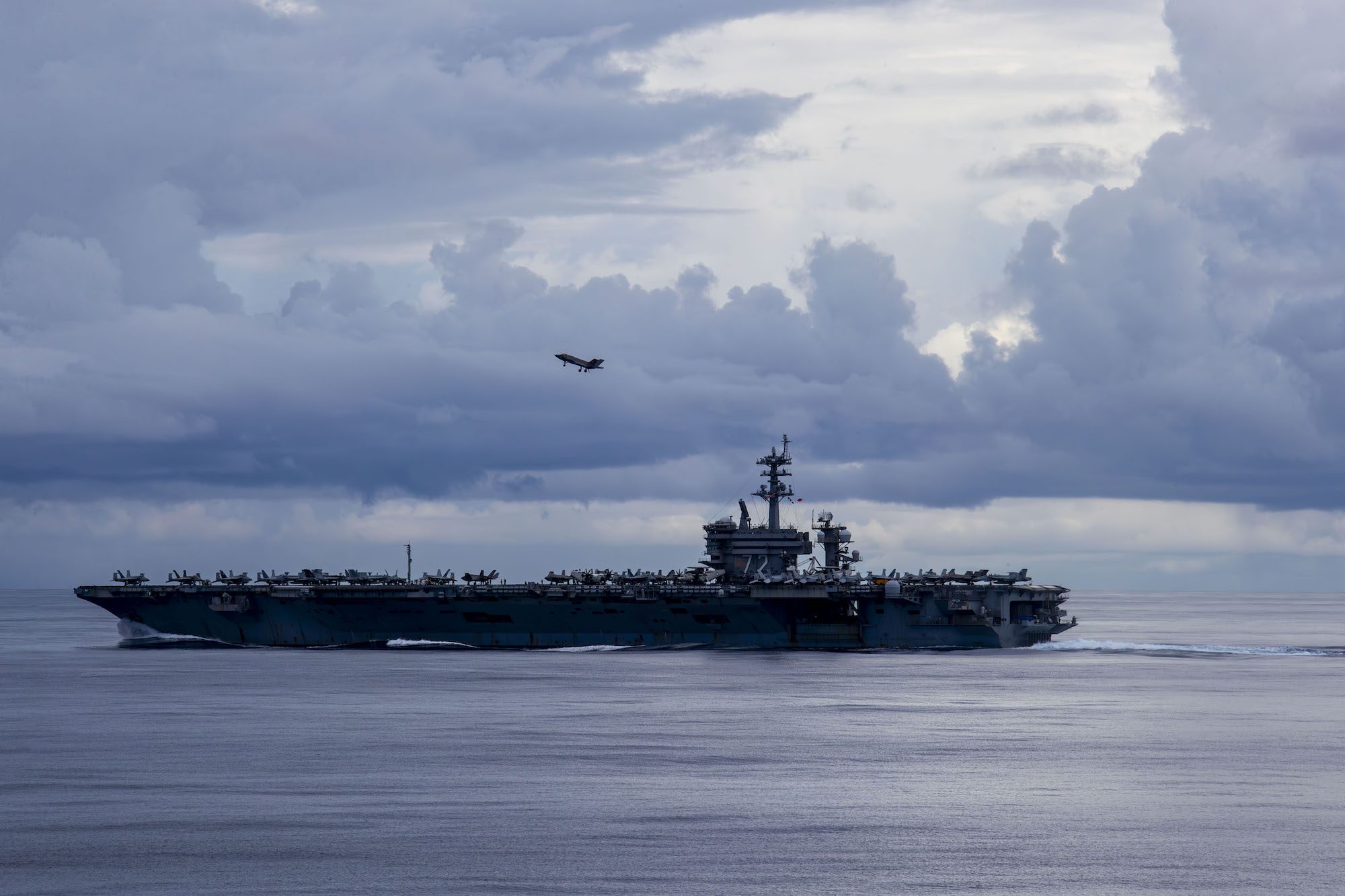 An F-35C Lightning II, assigned to Marine Fighter Attack Squadron (VMFA) 314, flies over the Nimitz-class aircraft carrier USS Abraham Lincoln (CVN 72), August 9, 2024. U.S. Navy Photo