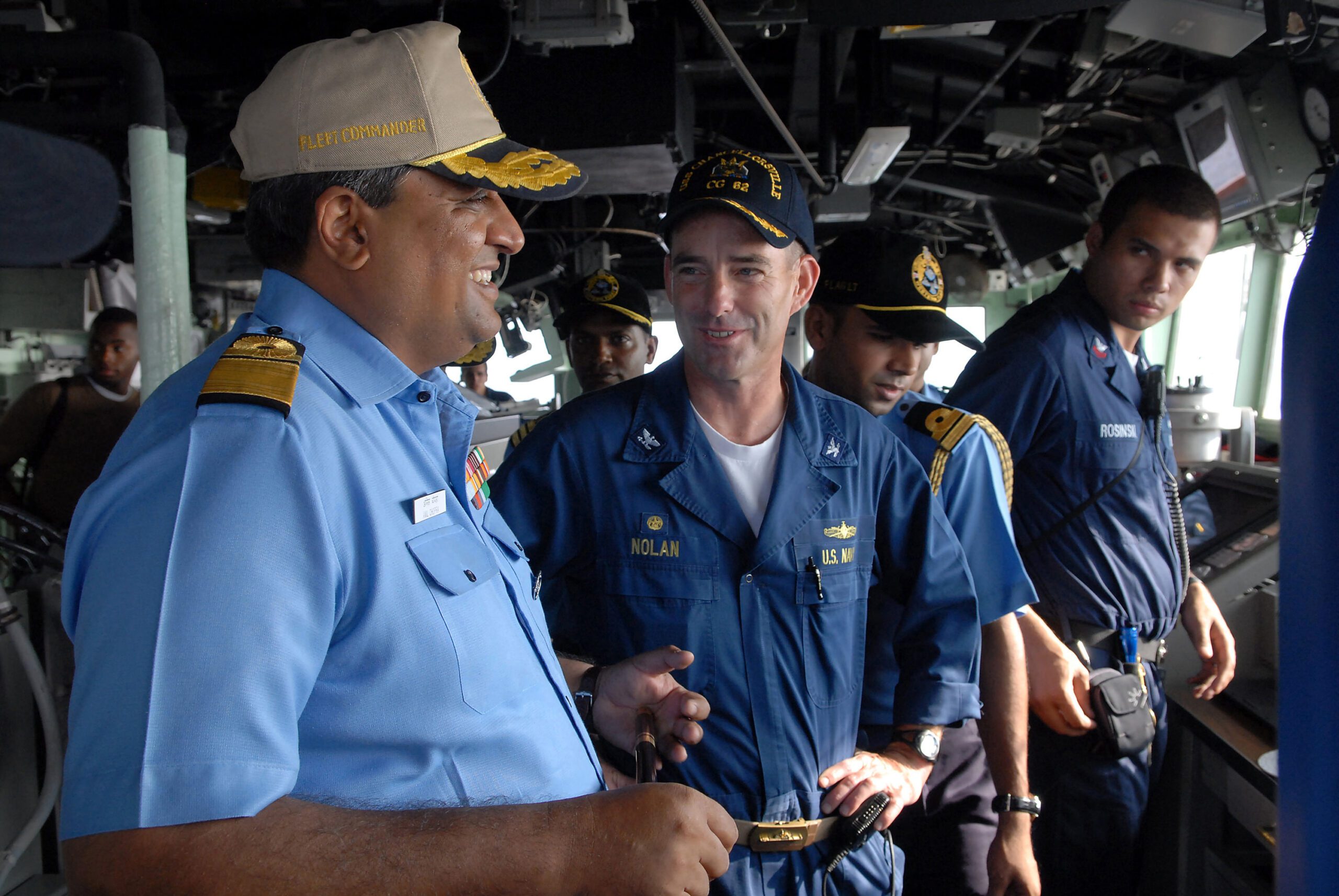 Photo of an Indian Navy Admiral on the bridge of a US Navy warship talking to a US Navy captain