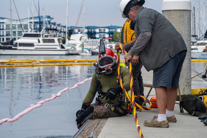 Salvage diver dons gear to inspect the underwater damage abaord the yacht Teh Admiral