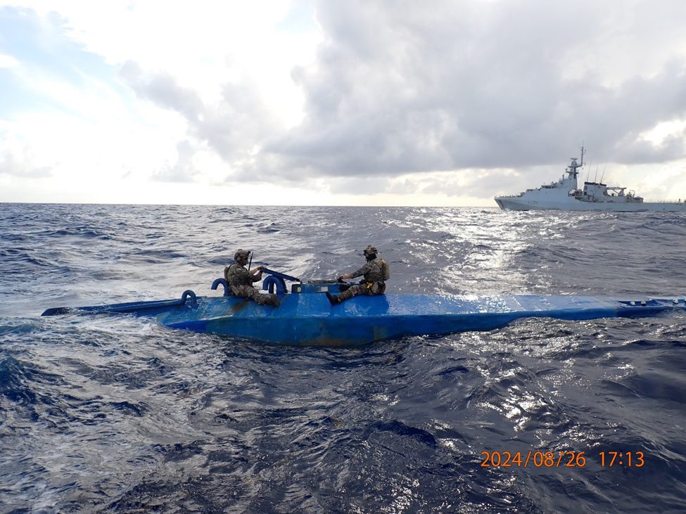 Crew members from U.S. Coast Guard Tactical Law Enforcement Detachment (LEDET) 111 and British Royal Navy team embarked aboard HMS Trent (P244) interdicts a semi-submersible drug smuggling vessel in the international waters of the Caribbean Sea