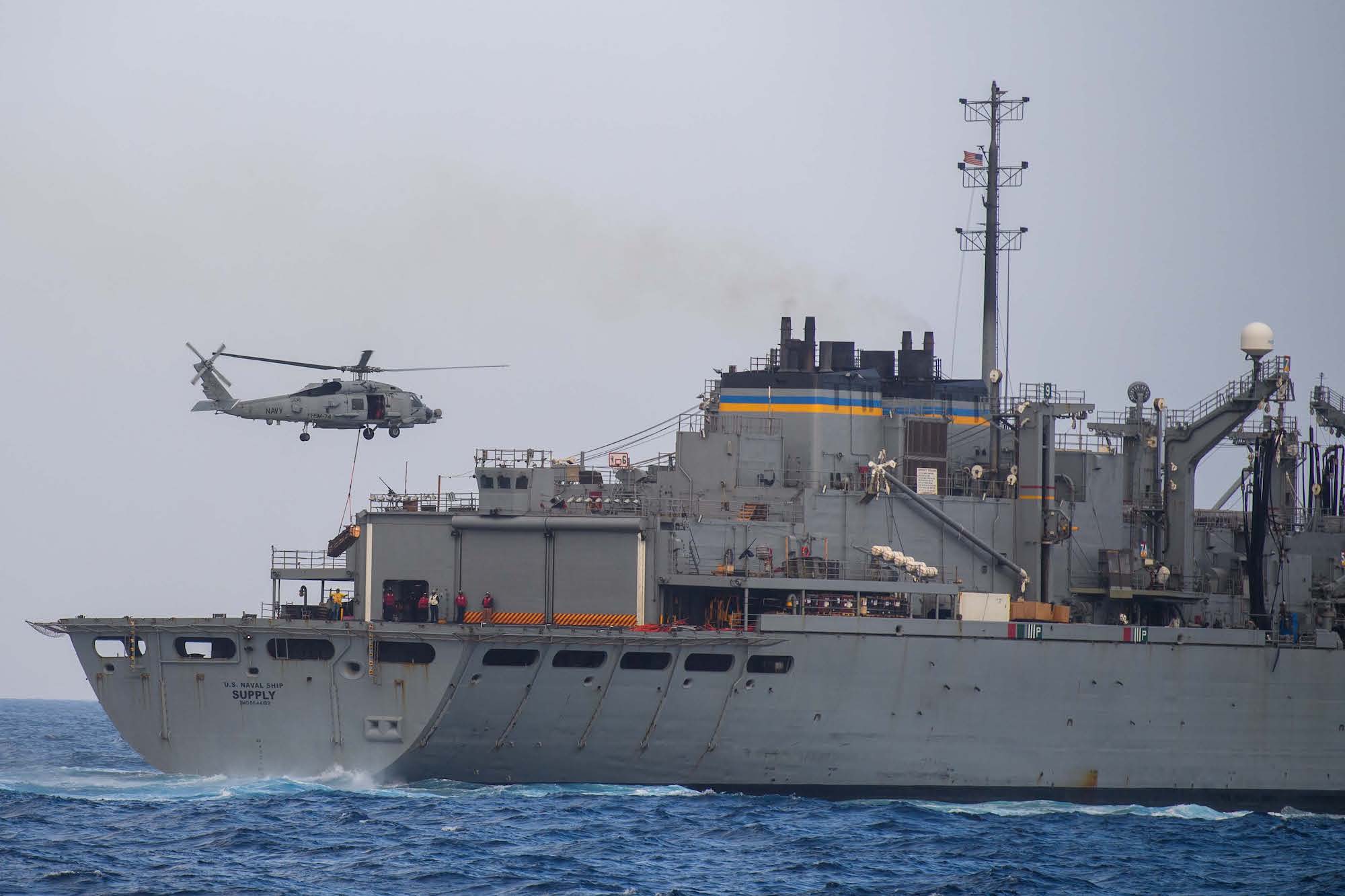 An MH-60R Sea Hawk helicopter, attached to the "Swamp Foxes" of Helicopter Maritime Strike Squadron (HSM) 74, conducts a vertical replenishment with the Supply-class fast combat support ship USNS Supply (T-AOE 6) in support of the Arleigh Burke-class guided-missile destroyer USS Mason (DDG 87) in the Red Sea, March 31, 2024. U.S. Navy Photo