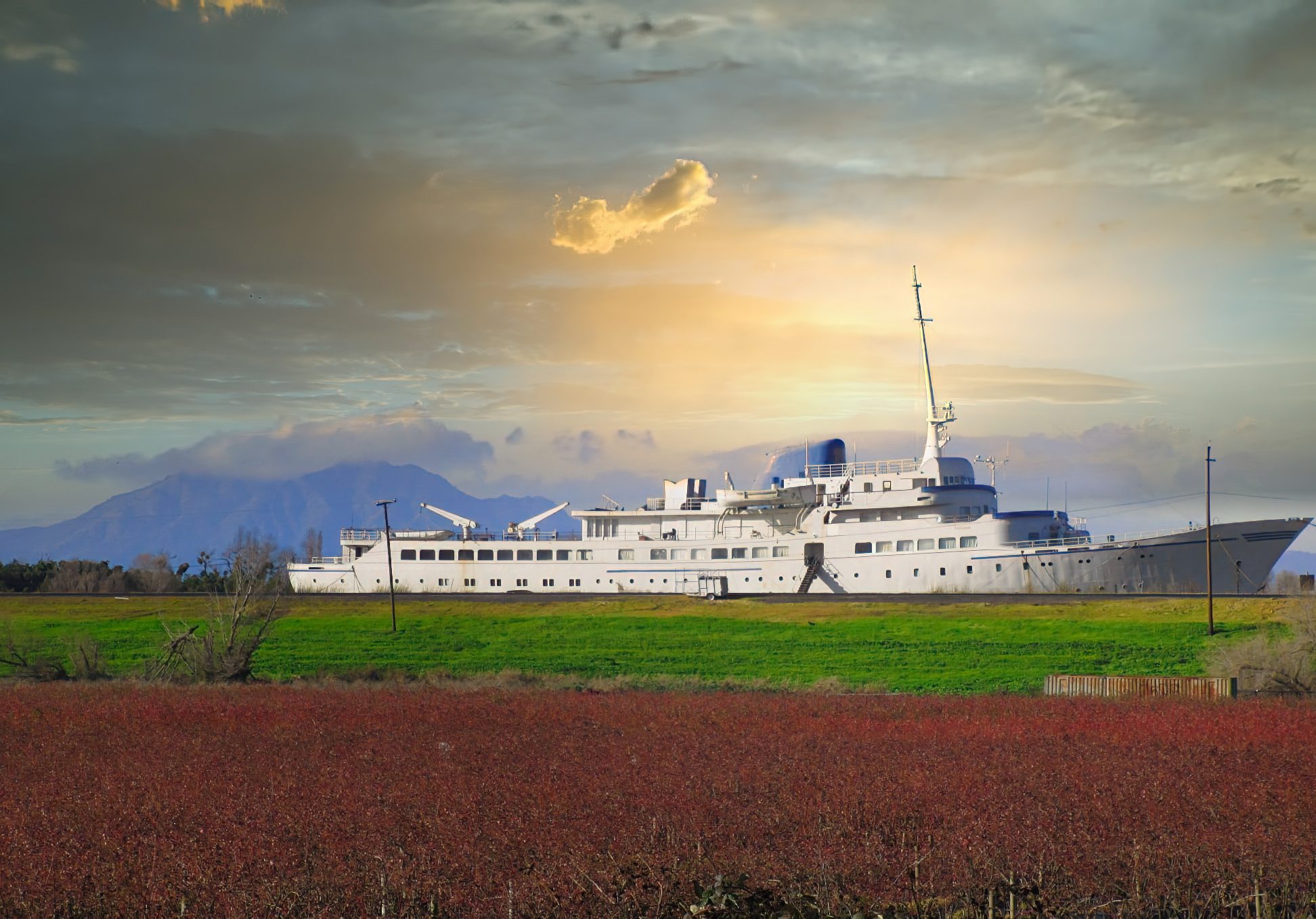 Vintage german cruise ship next to green field in california