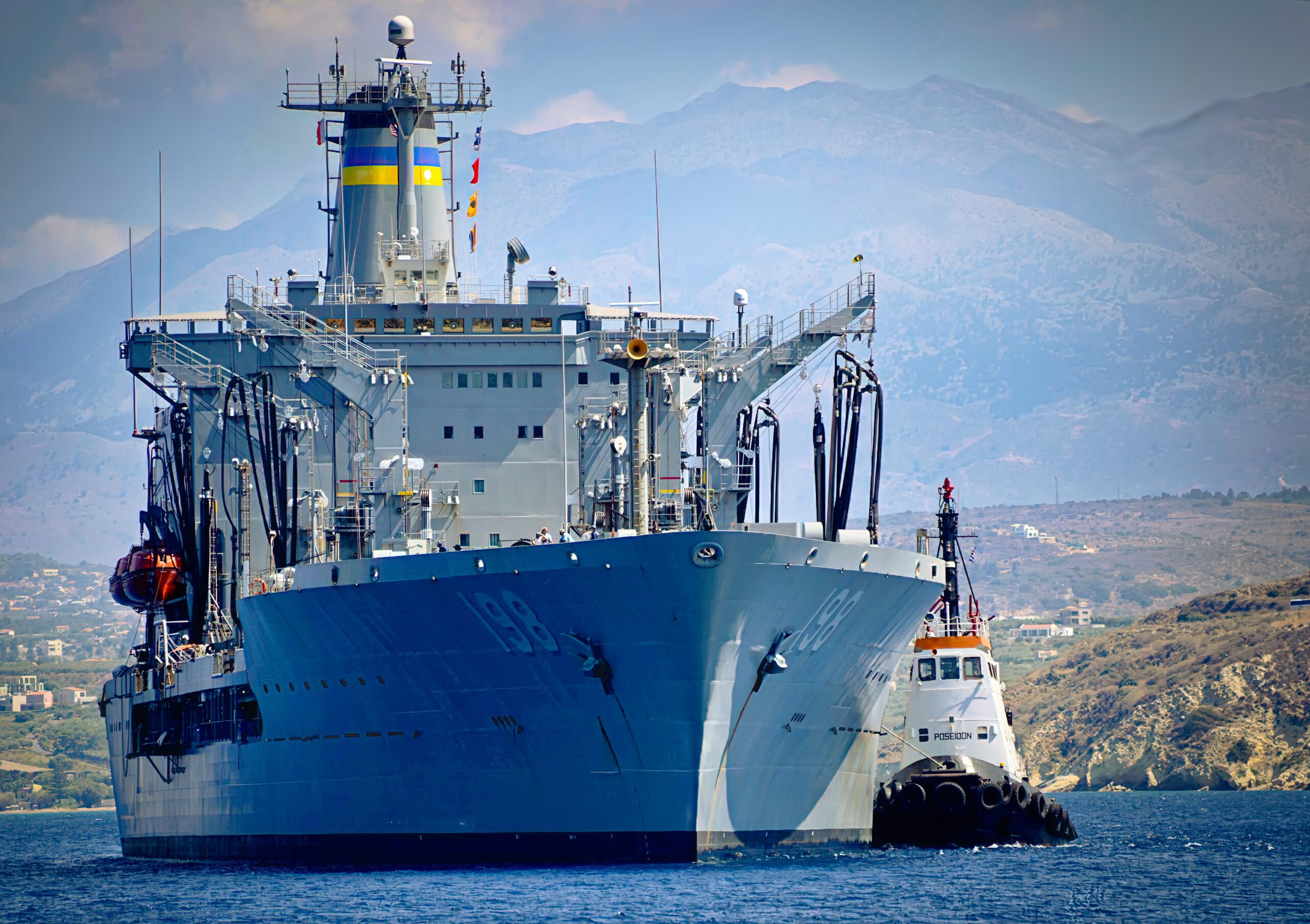 Big Horn, a Henry J. Kaiser-class fleet replenishment oiler with tugboat arriving in port