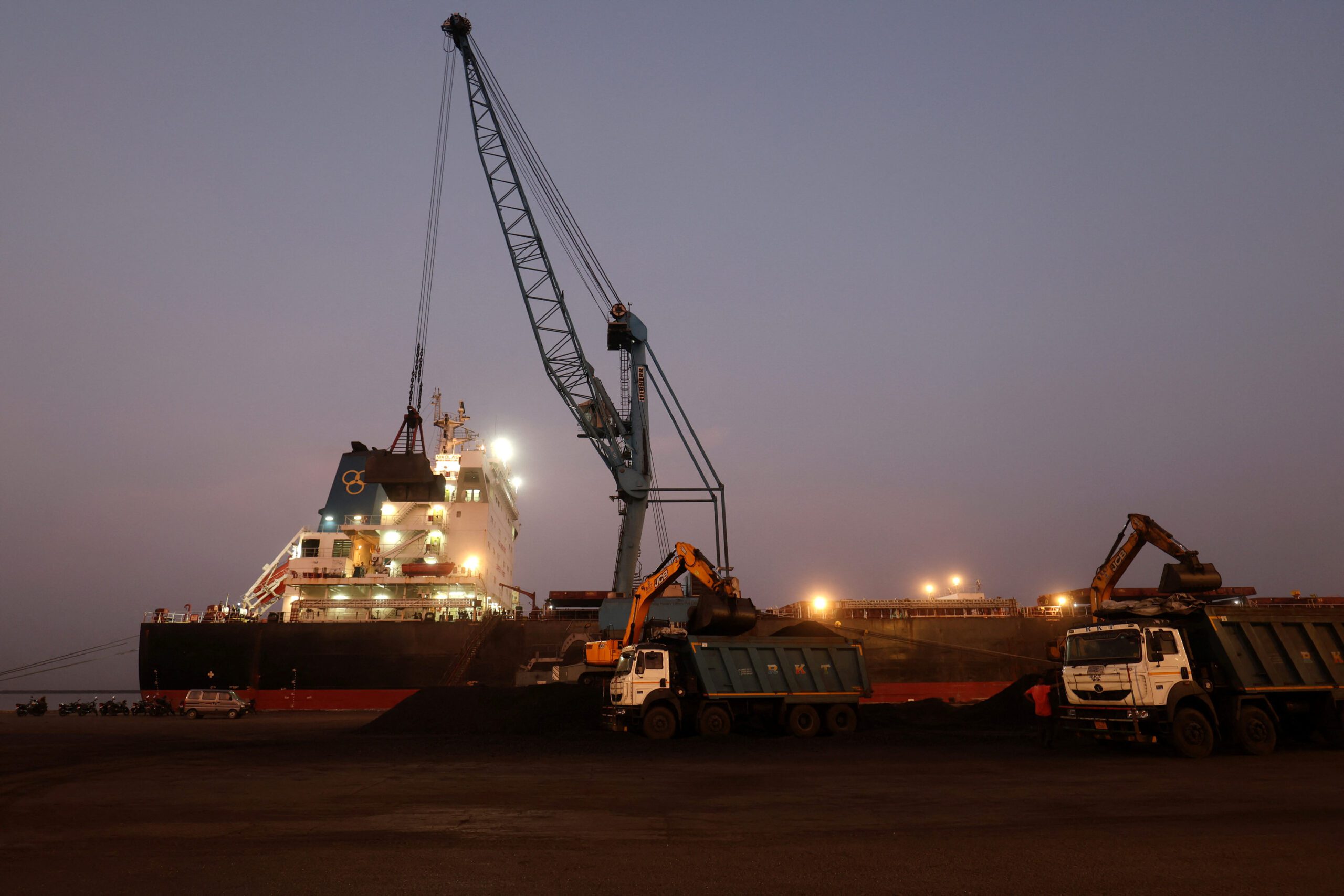 A crane is used to unload coal from a cargo ship at the Deendayal Port in Kandla.