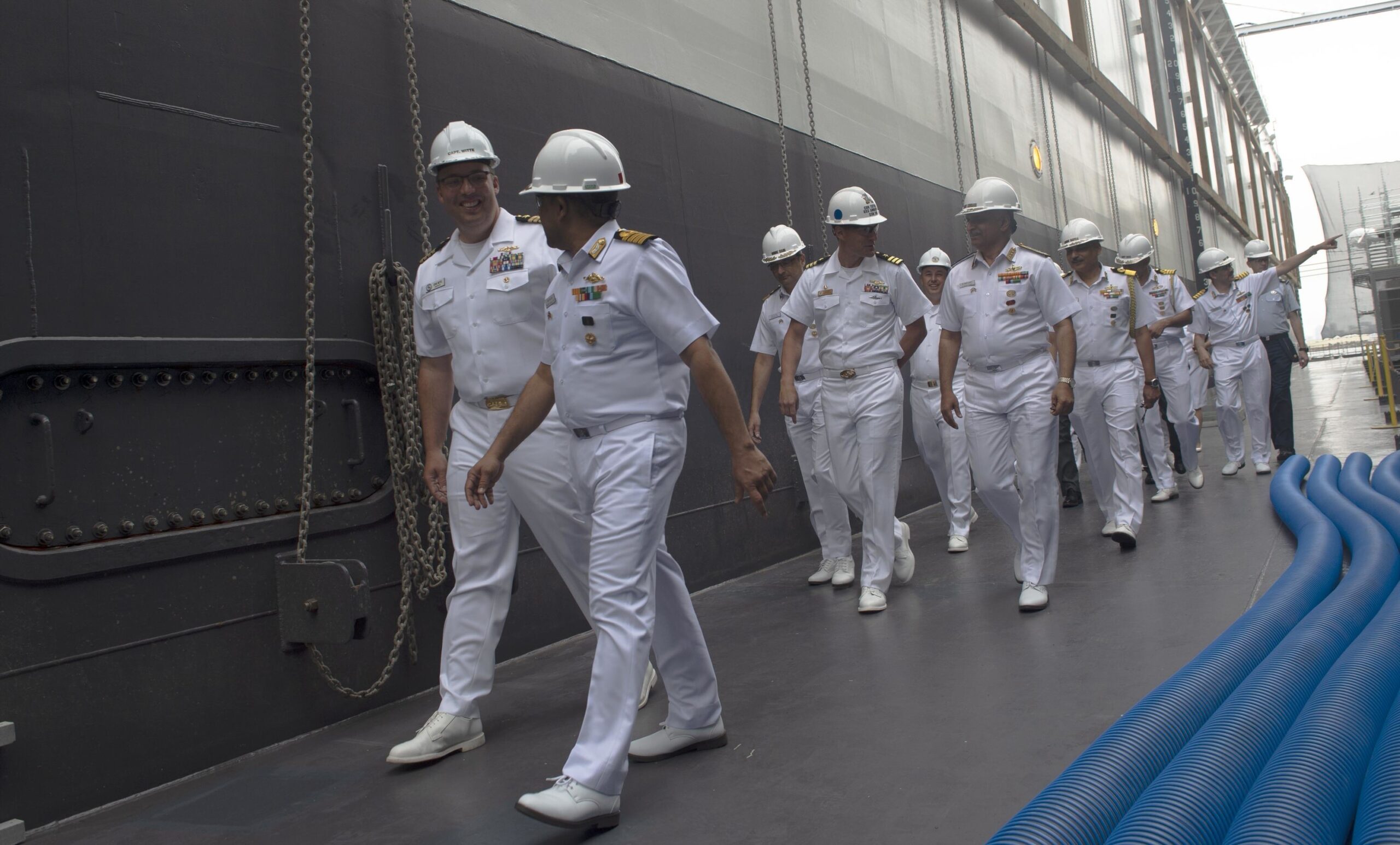 Indian and US Navy officers walking in dress whites