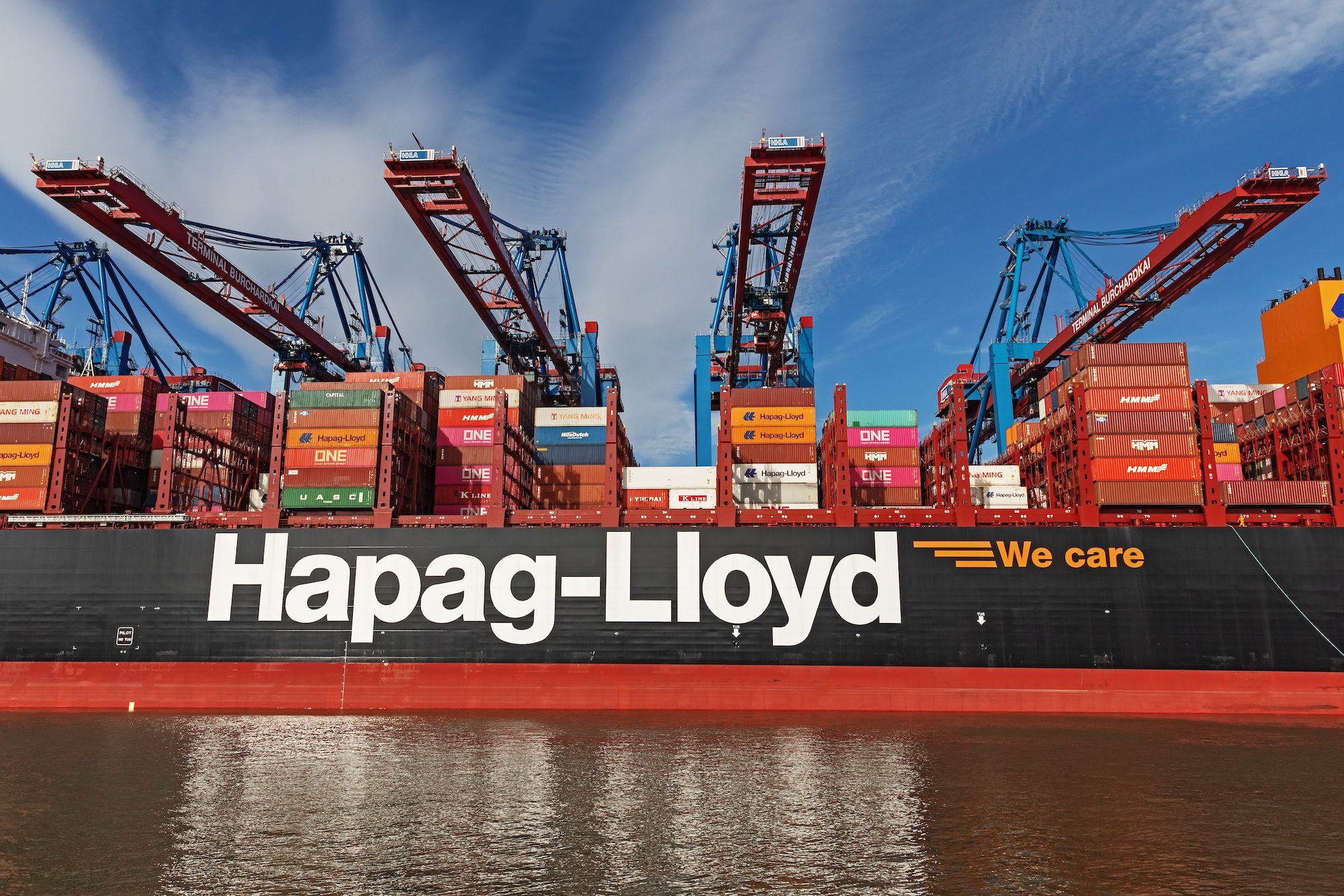 The newest ultra large container ship Manila Express of Hapag-Lloyd with container cranes at the Burchardkai in the in the Port of Hamburg