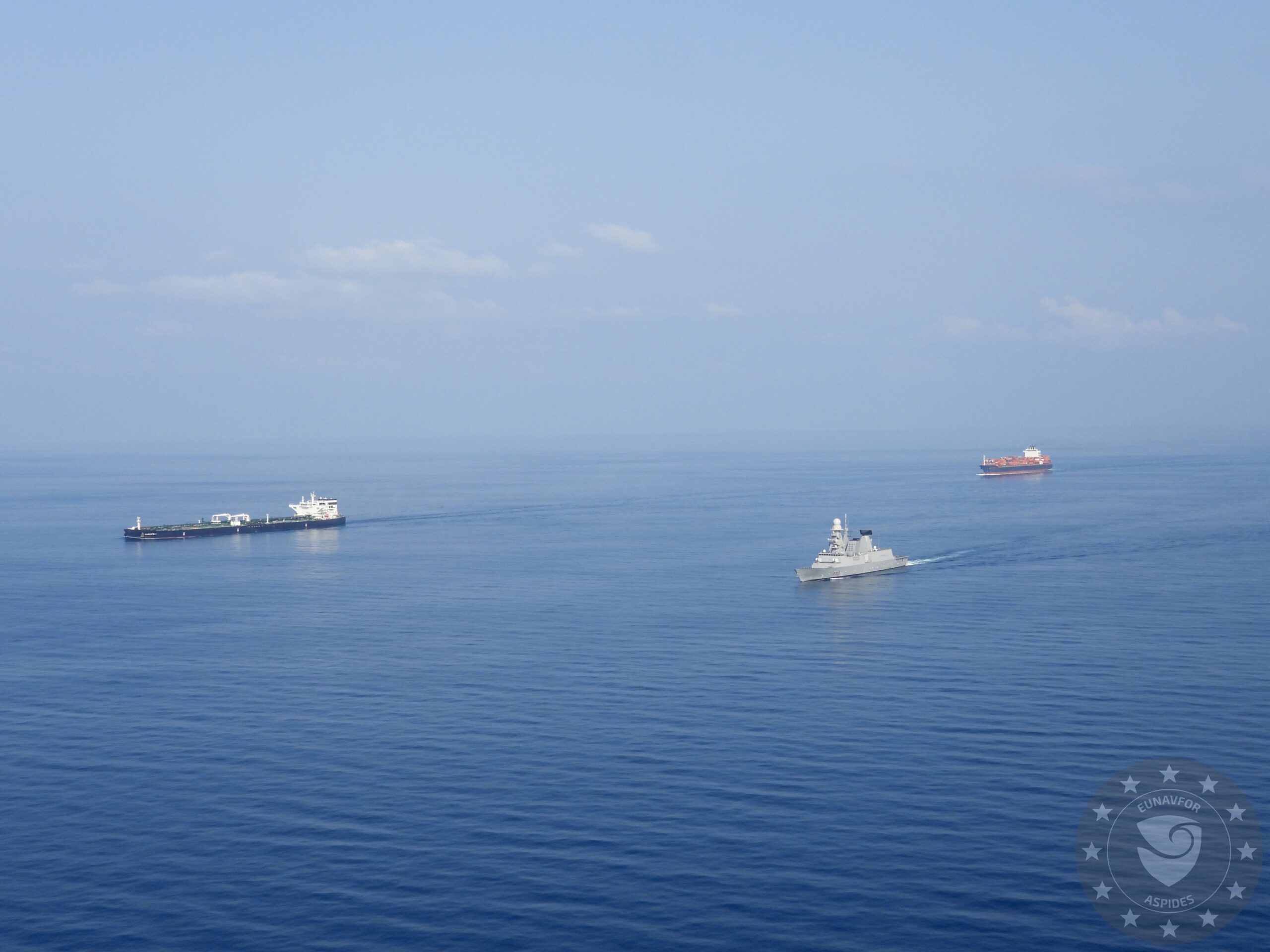 A warship with the EU's Operation Aspides escorts a tanker and cargo ship sail through the Southern Red Sea. Photo courtesy Operation Aspides