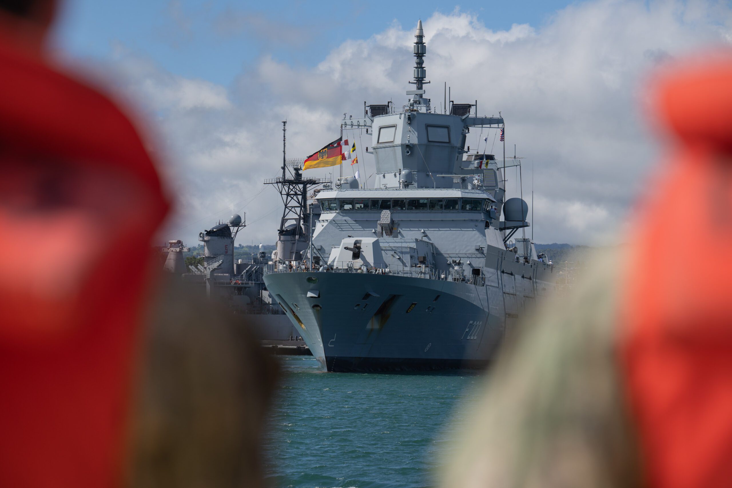 German navy ship at dock flying flags