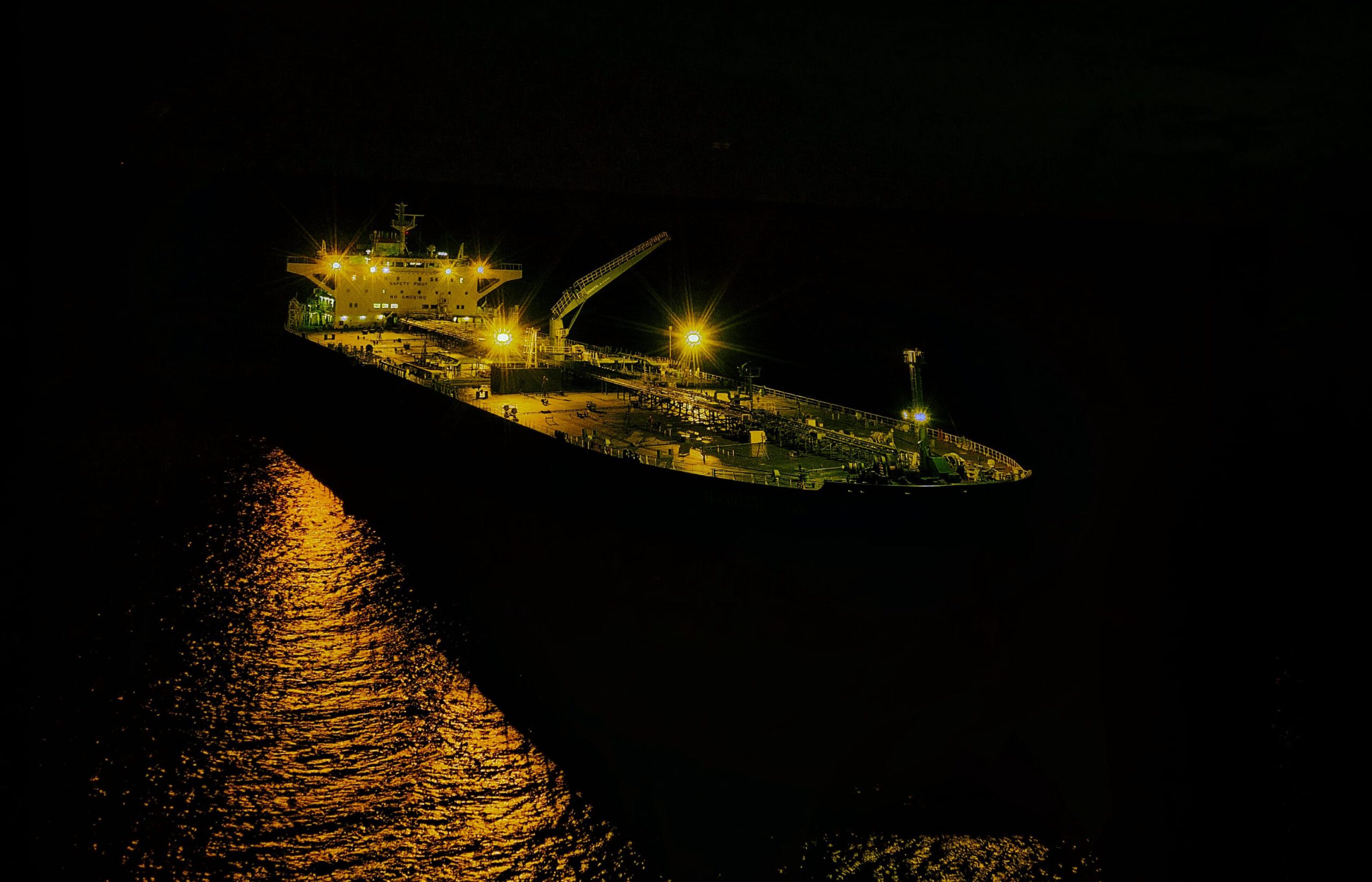 An anchored tanker ship at night