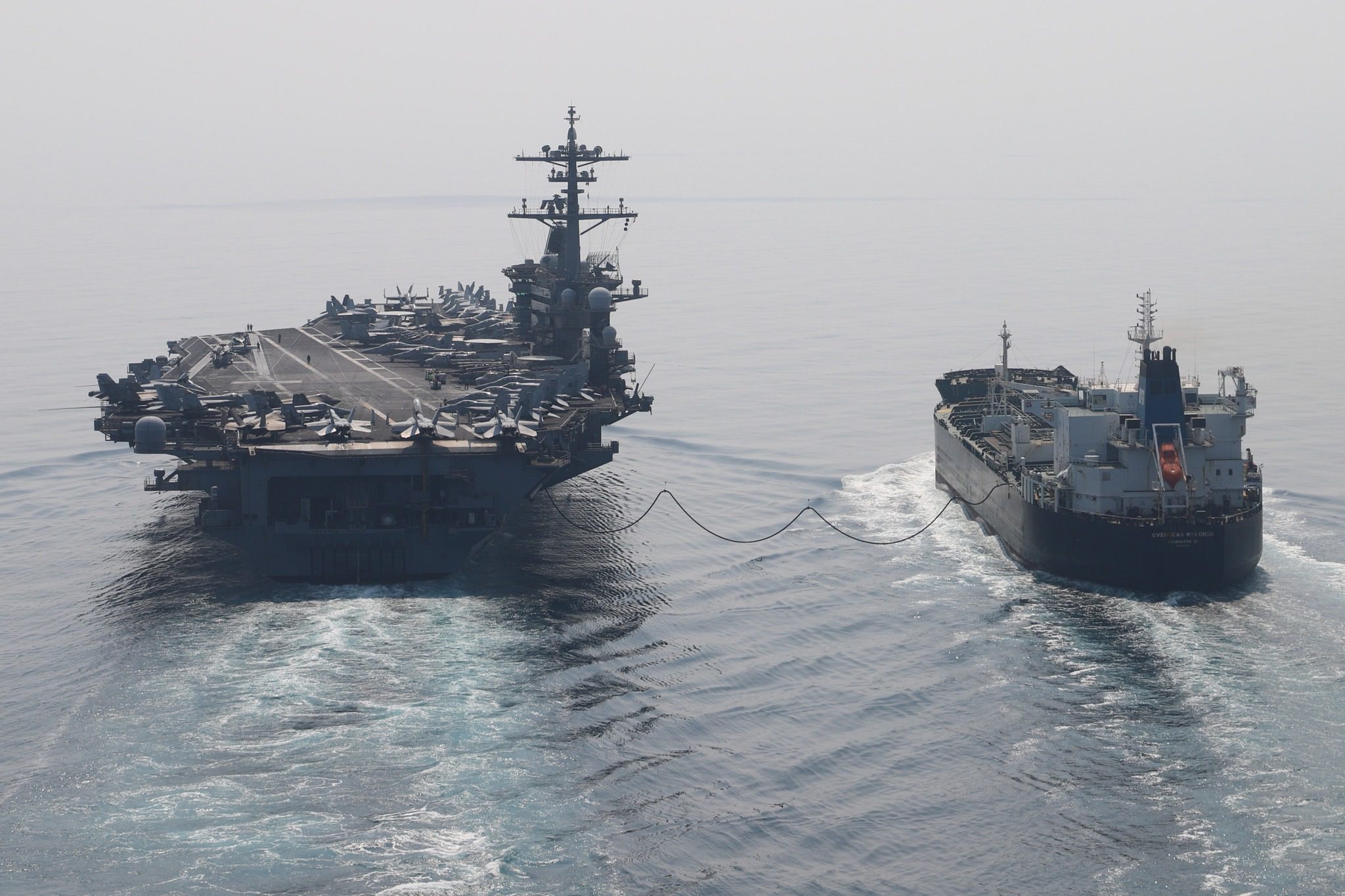 The Nimitz-class aircraft carrier USS Abraham Lincoln (CVN 72) sails alongside the Chemical/Oil Tanker Overseas Mykonos during a fueling-at-sea. U.S. Navy Photo