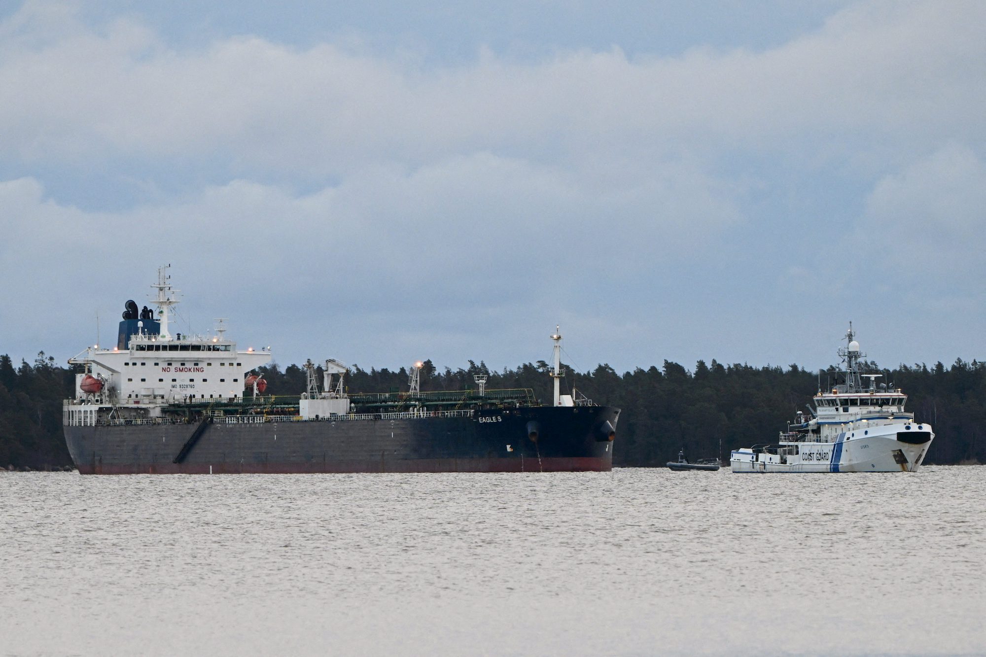 Finnish Coast Guard Uisko keeps watch on oil tanker Eagle S anchored near the Kilpilahti port in Porvoo, on the Gulf of Finland