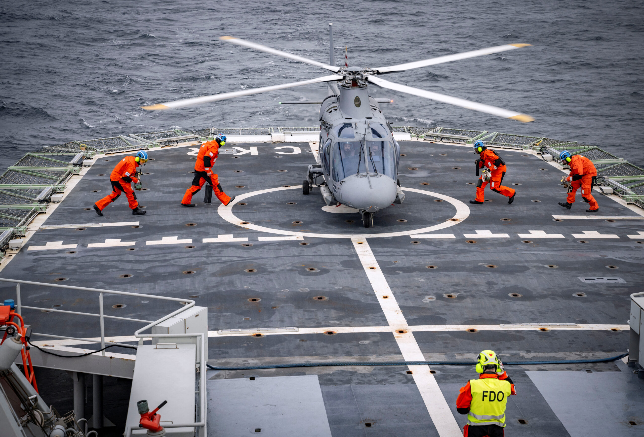 The NATO flag is hoisted on the patrol ship HMS Carlskrona for the first time