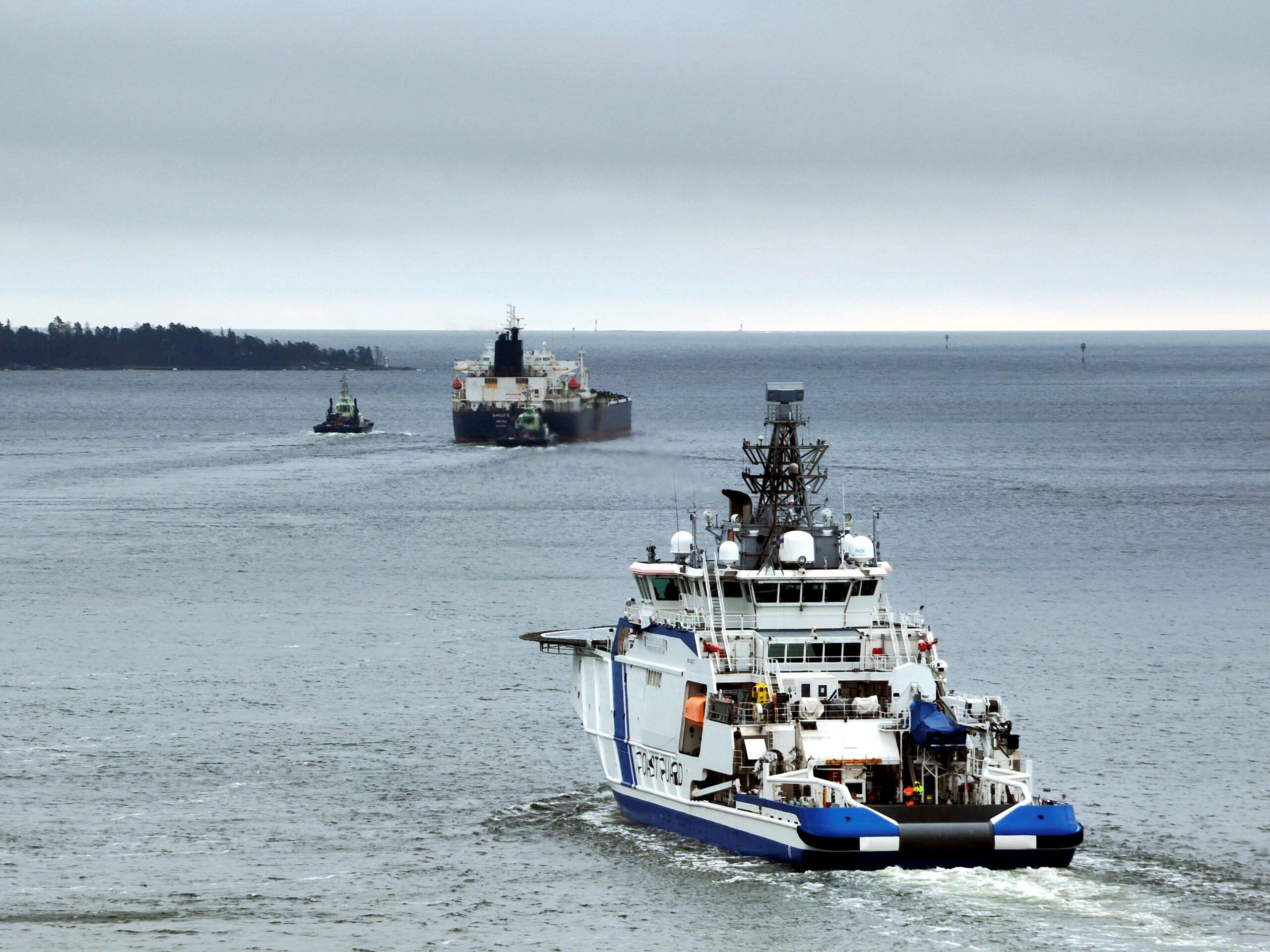 Finnish Border Guard's ship Turva escorts Cook Islands-registered oil tanker Eagle S to sea.Handout via REUTERS