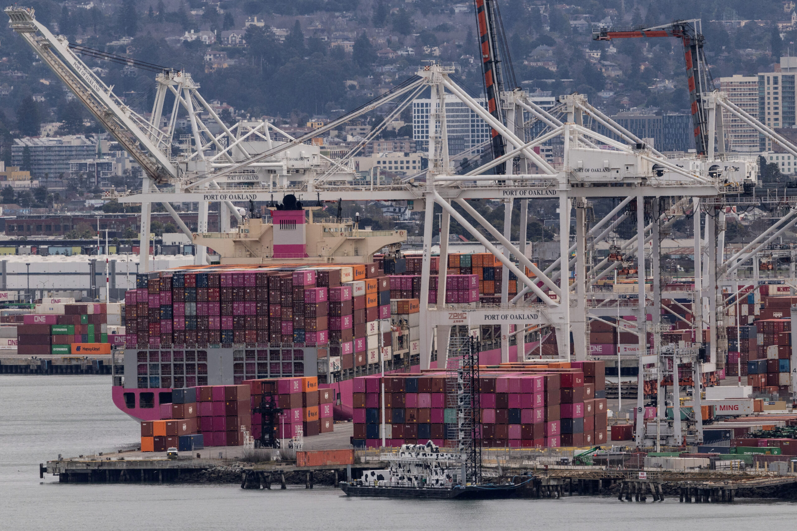 A cargo ship full of shipping containers is seen at the port of Oakland as trade tensions escalate over U.S. tariffs.