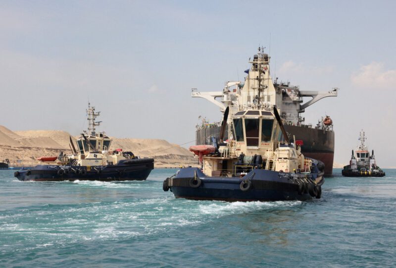 Tugboats help tow the Greek-registered MT Sounion