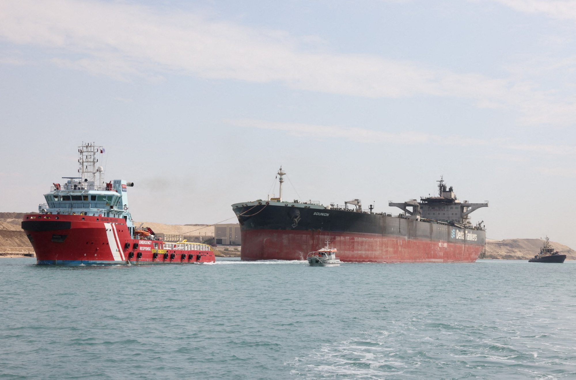 Tugboats help tow the Greek-registered MT Sounion, which was attacked by Yemen's Houthi militants last year in the Red Sea