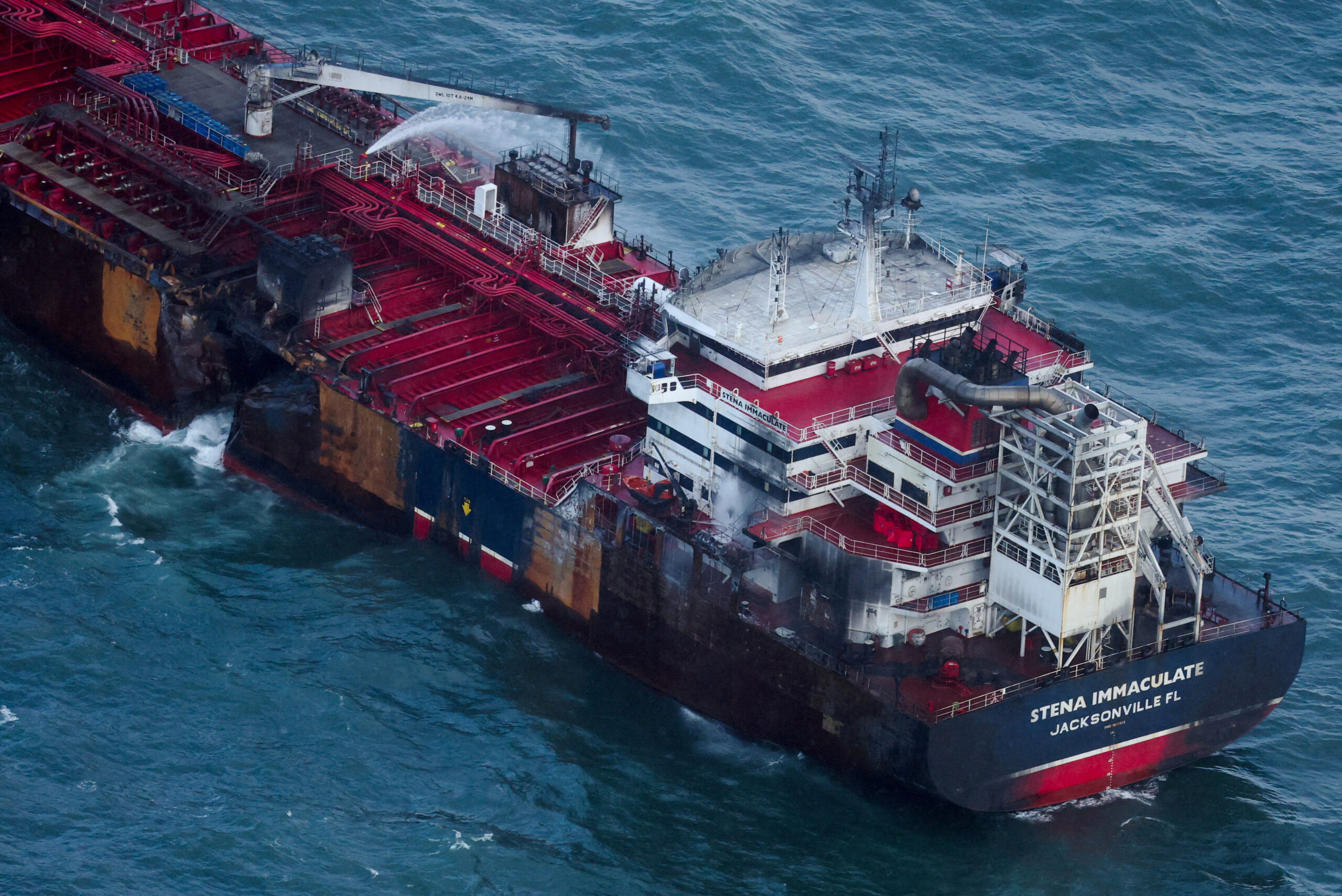 Aftermath of collision between container ship and oil tanker