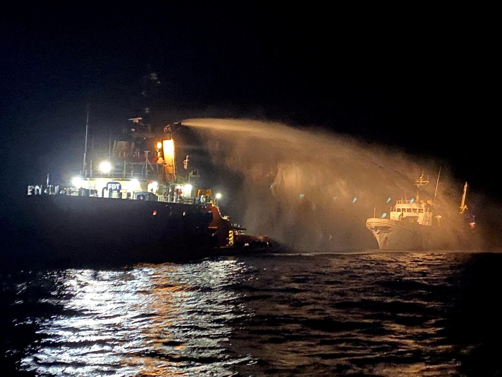A tug puts out a fire on the Gaza Freedom Flotilla vessel Conscience outside Maltese territorial waters