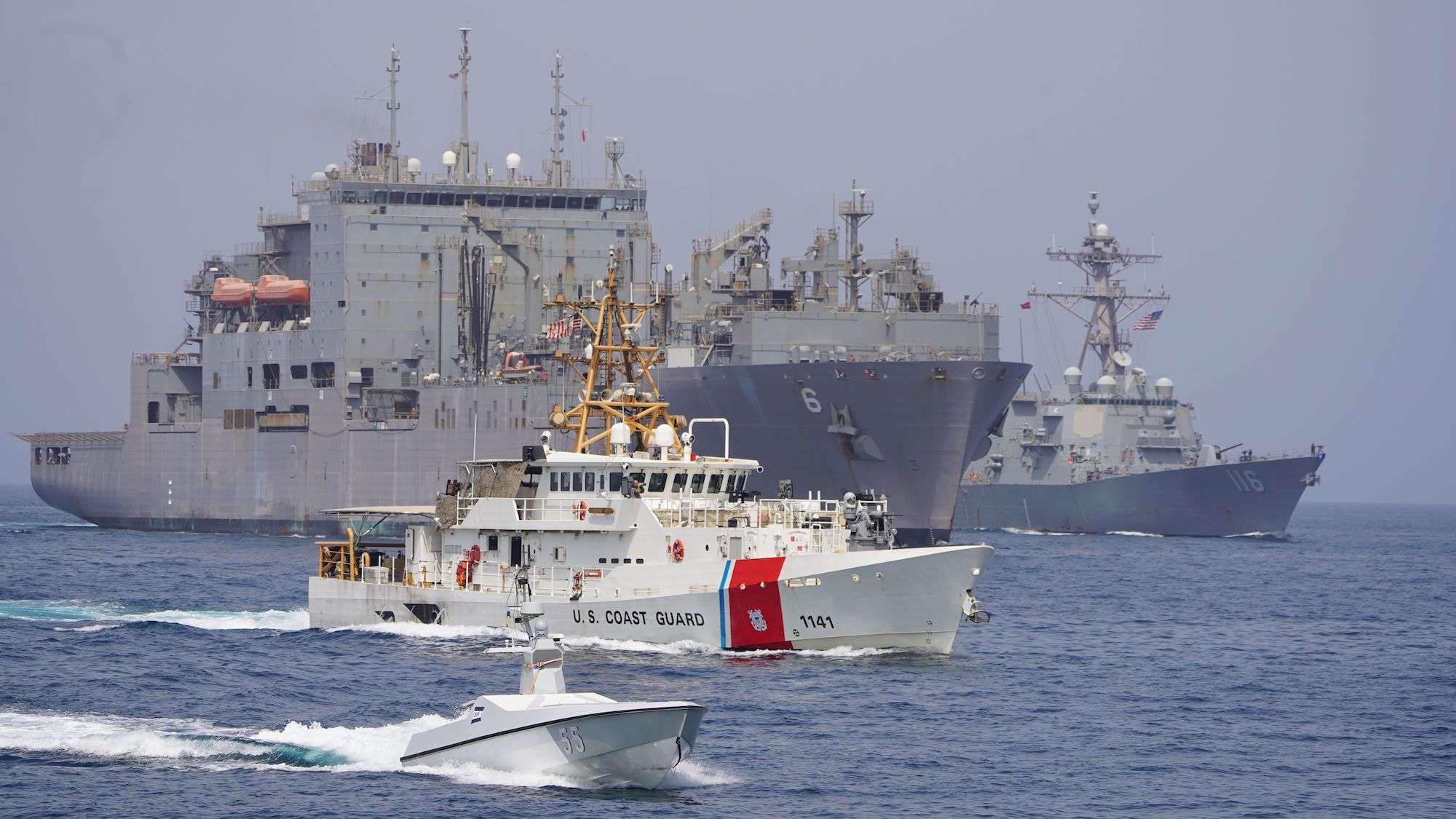 An L3 Harris Arabian Fox MAST-13 unmanned surface vessel, U.S. Coast Guard fast response cutter USCGC Charles Moulthrope (WPC 1141), dry cargo and ammunition ship USNS Amelia Earhart (T-AKE 6) and guided-missile destroyer USS Thomas Hudner (DDG 116) sail together during a transit through the Strait of Hormuz