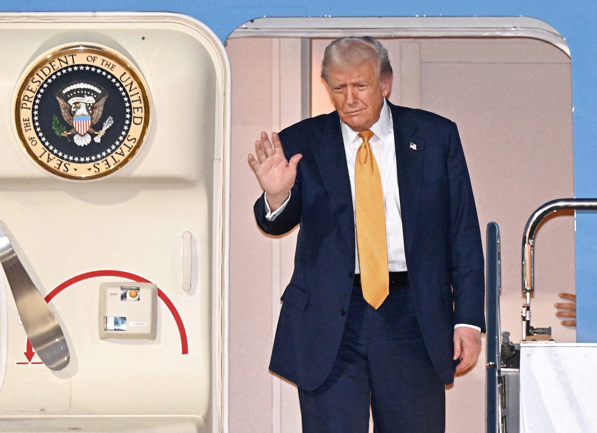 U.S. President Donald Trump waves upon his arrival at Haneda airport in Tokyo, Japan