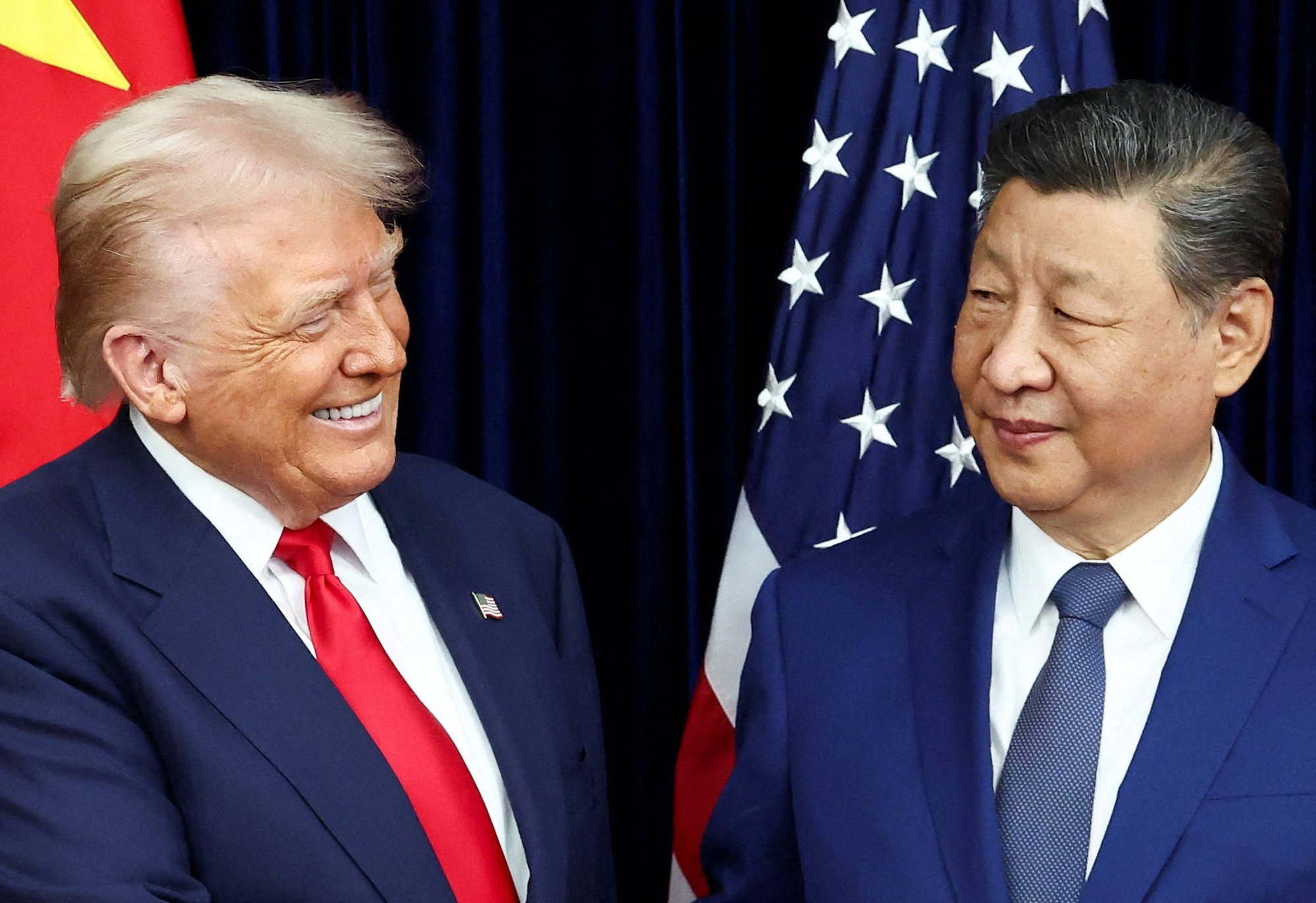 U.S. President Donald Trump and Chinese President Xi Jinping react as they hold a bilateral meeting at Gimhae International Airport, on the sidelines of the Asia-Pacific Economic Cooperation (APEC) summit, in Busan, South Korea