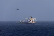 A U.S. military helicopter flies over the Panama-flagged Centuries, which was intercepted by the U.S. Coast Guard, days after U.S. President Donald Trump announced a "blockade" of all sanctioned oil tankers entering and leaving Venezuela, east of Barbados in the Caribbean Sea
