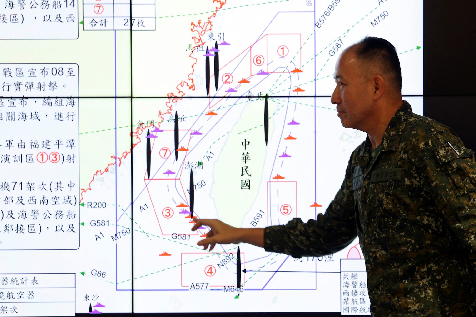 Hsieh Jih-sheng, deputy chief of the general staff for intelligence at Taiwan's defence ministry, points at a map during a press conference about China’s military drills around Taiwan,