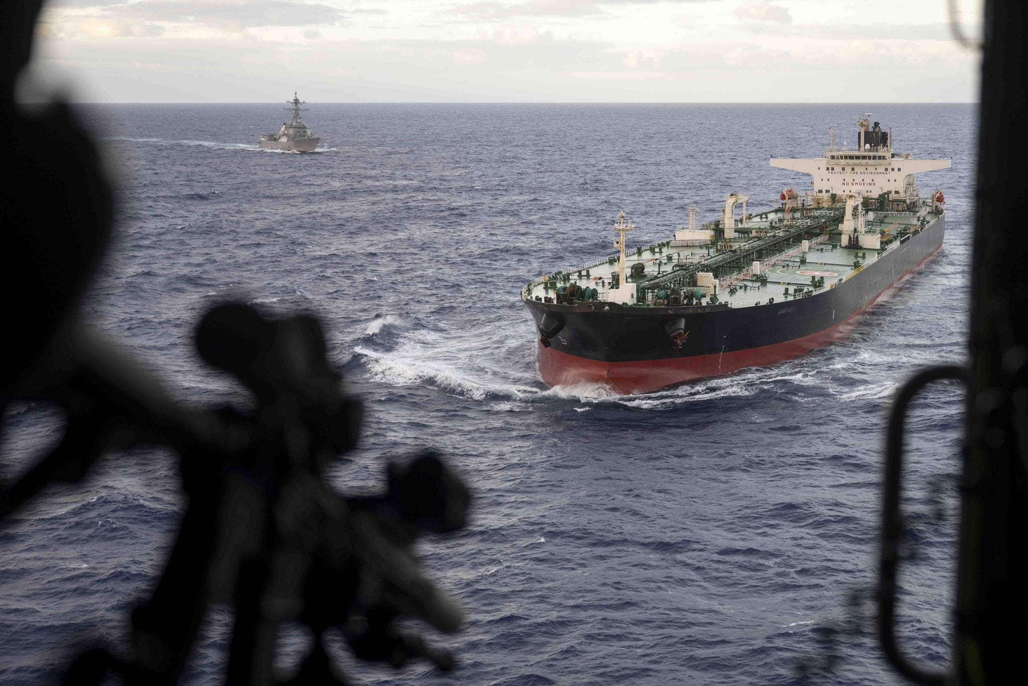 U.S. Navy warship escorts the sanctioned crude tanker Aquila II during a maritime interdiction operation at sea.