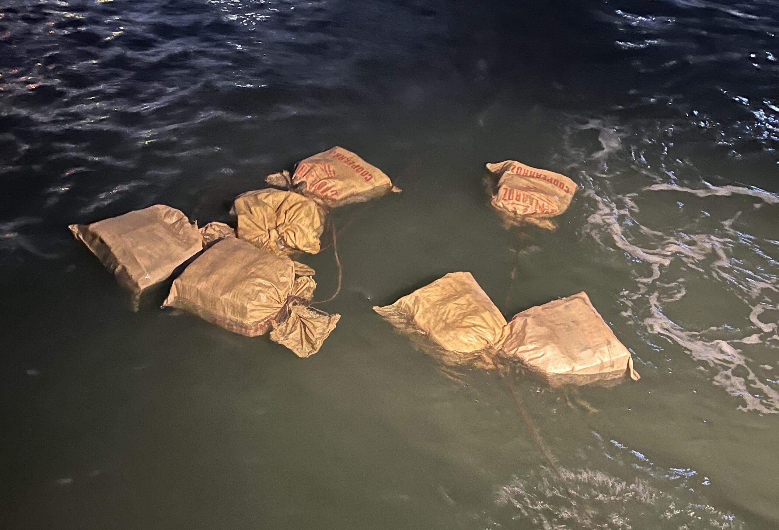 Packages of cocaine in the water following an drug smuggling operation involving a stowaway in San Juan Harbor