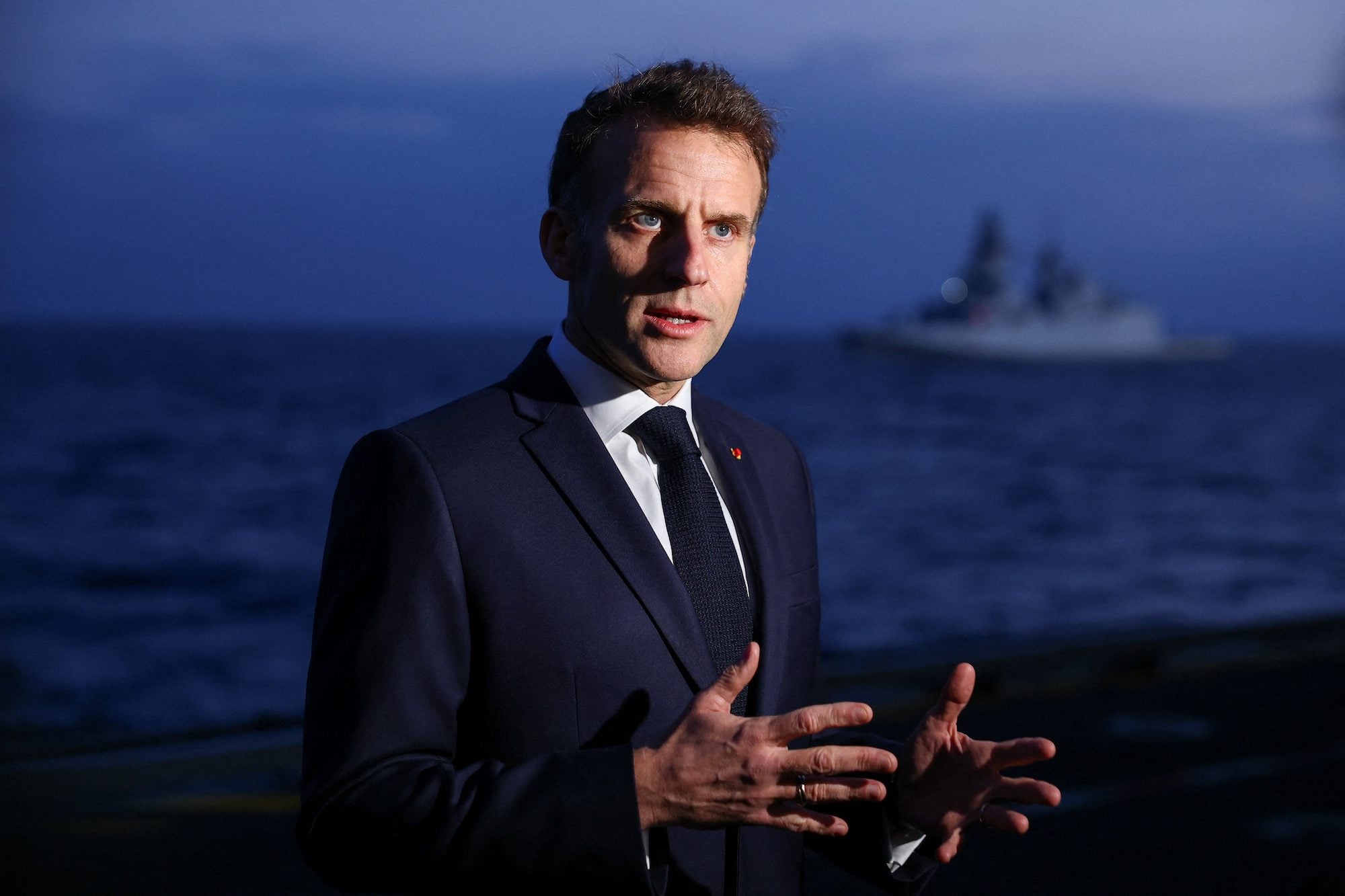 French President Emmanuel Macron speaks to members of the media as he visits the French aircraft carrier Charles de Gaulle, on the day of his visit to Cyprus