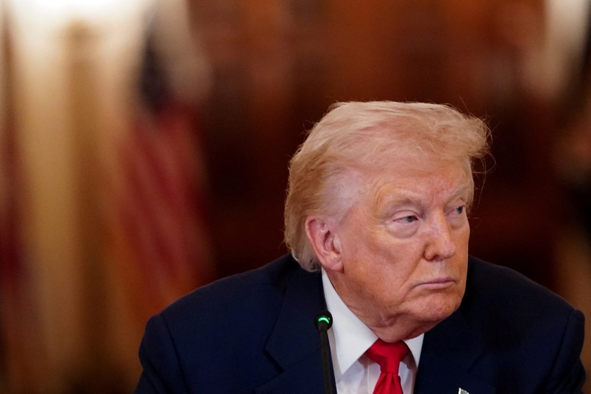 FILE PHOTO: U.S. President Donald Trump looks on during a round table on collegiate sports in the White House in Washington, D.C.