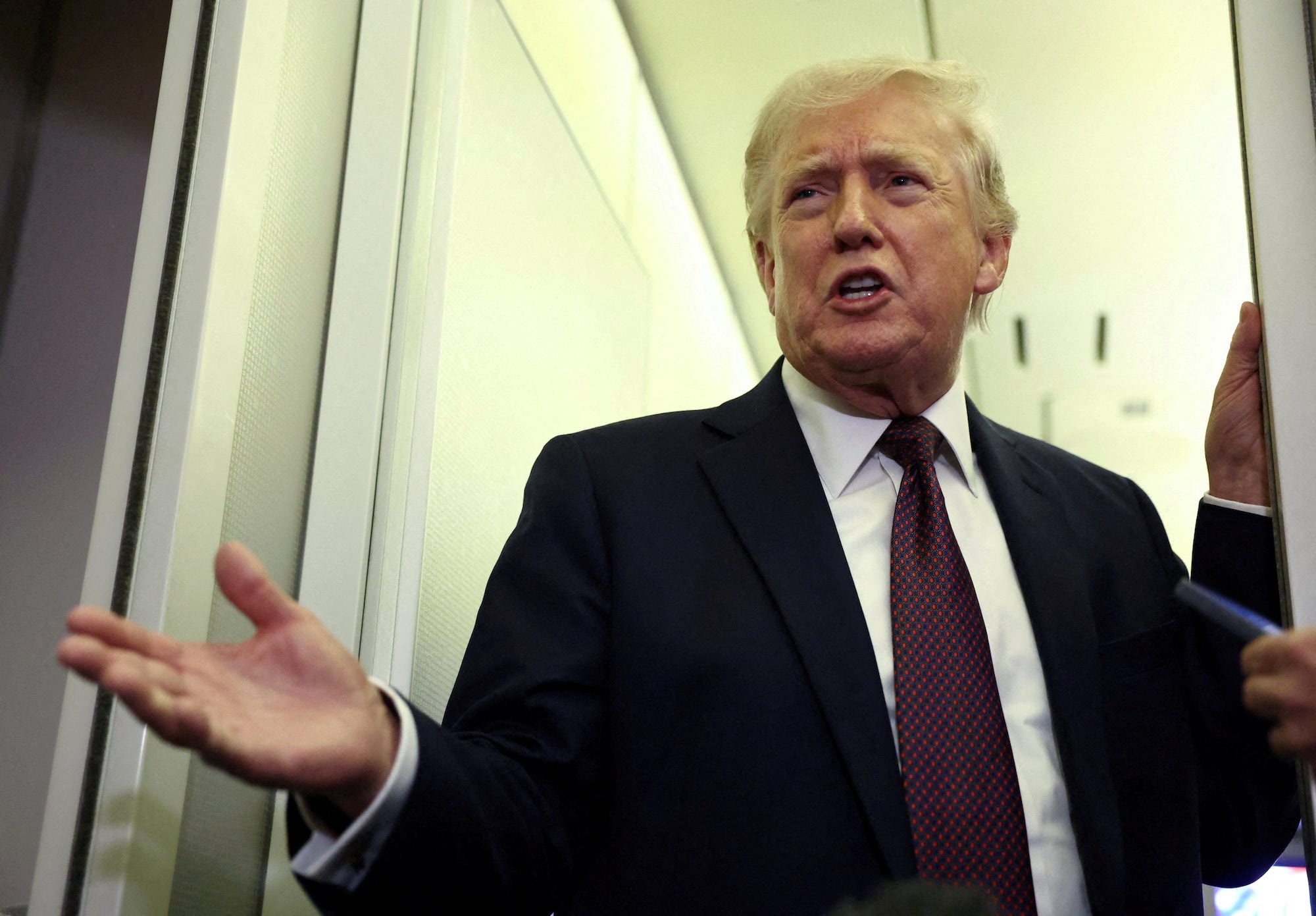 FILE PHOTO: U.S. President Donald Trump speaks to reporters aboard Air Force One on a flight back to Washington March 15, 2026