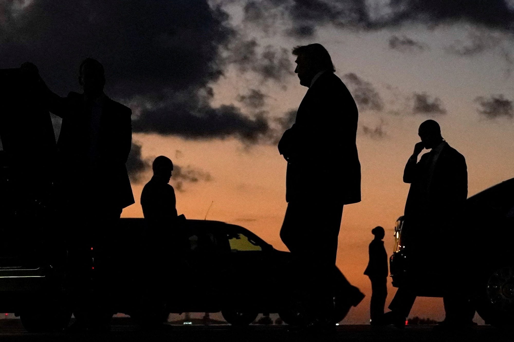U.S. President Donald Trump is silhouetted as he walks upon arrival at Palm Beach International Airport in West Palm Beach, Florida
