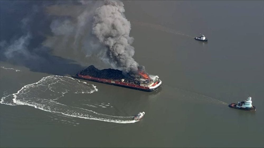 A screenshot from aerial video posted online showing the fire on a barge towed by the tug Douglas J