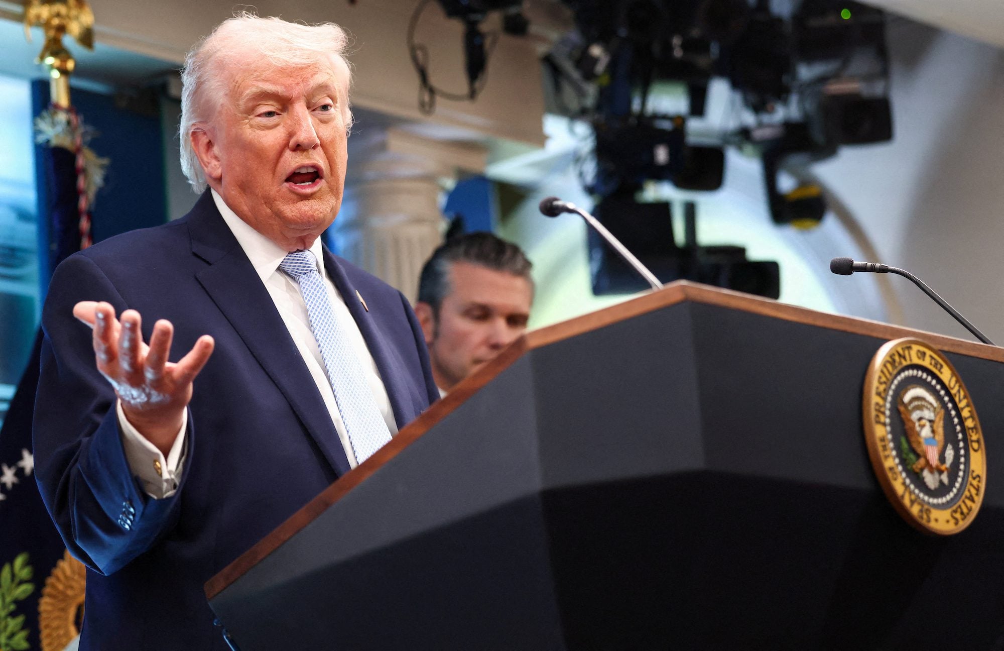 FILE PHOTO: U.S. President Donald Trump, flanked by Secretary of Defense Pete Hegseth, speaks during a press conference in the James S. Brady Press Briefing Room at the White House in Washington, D.C., U.S., April 6, 2026