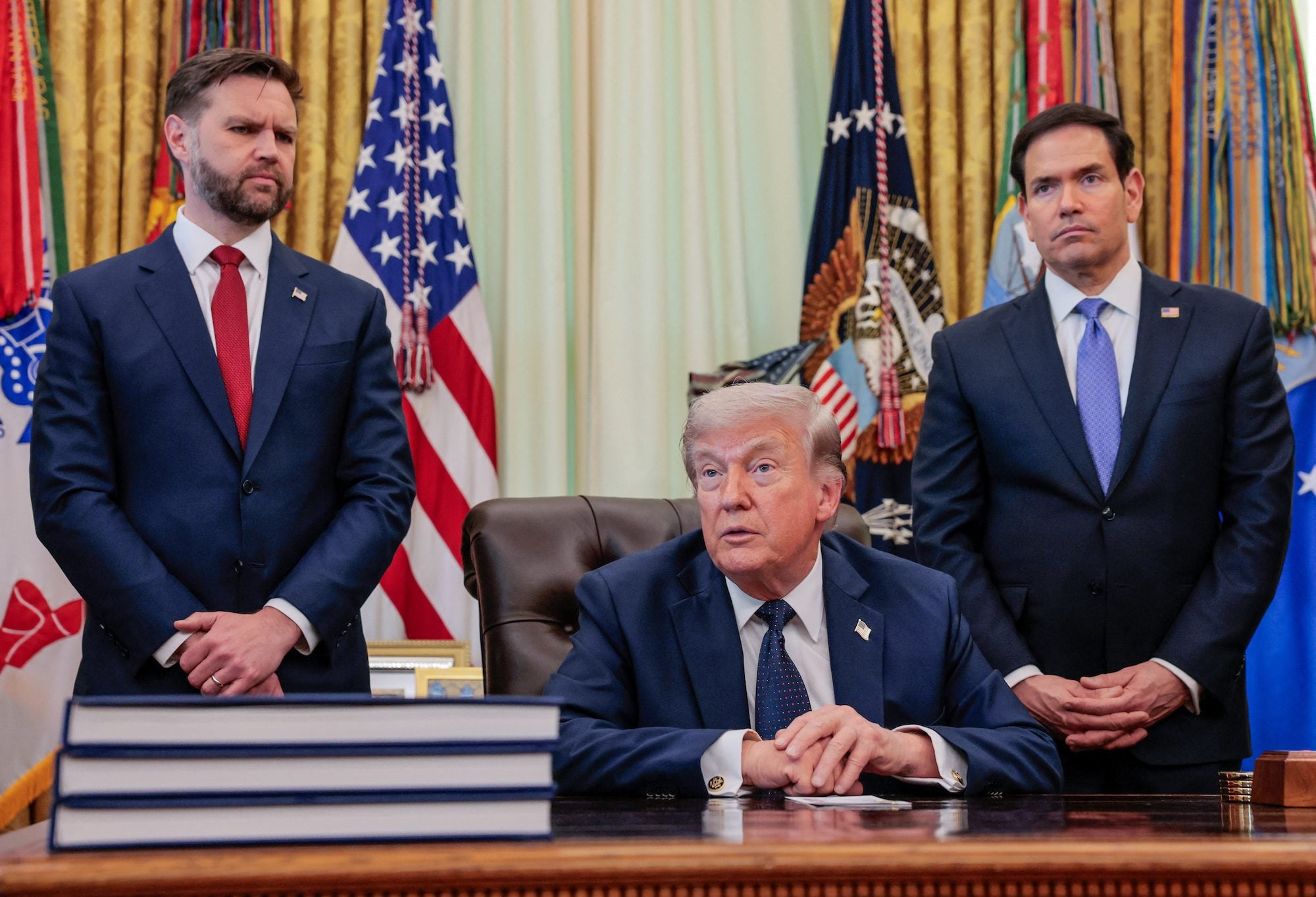 U.S. President Donald Trump speaks in the Oval Office, with Vice President JD Vance and Secretary of State Marco Rubio standing behind him, at the White House in Washington, D.C., U.S., April 23, 2026