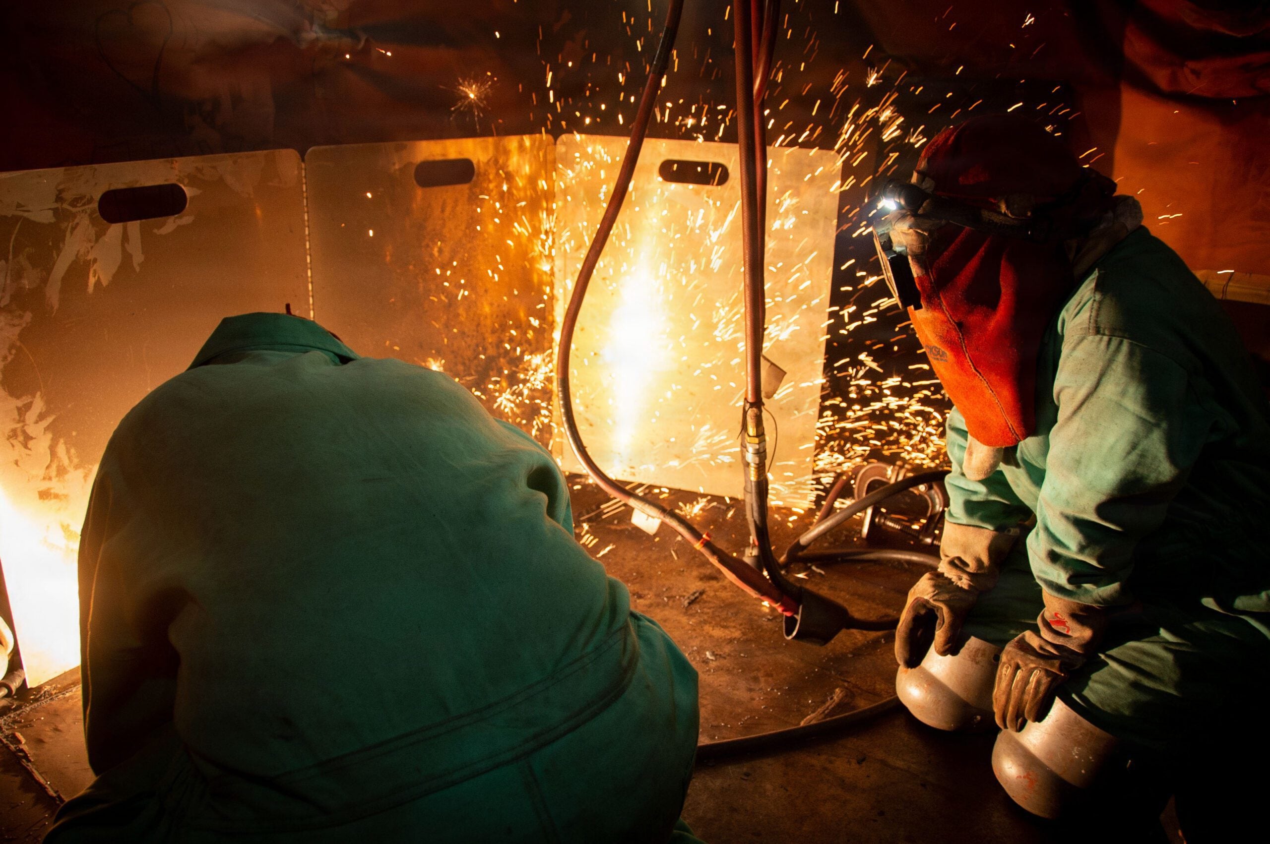 Nimitz-class aircraft carrier Ronald Reagan undergoing scheduled maintenance by shipyard welders