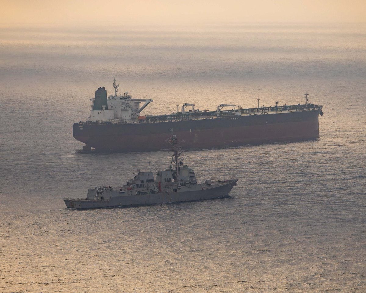 USS Rafael Peralta (DDG 115) near what the U.S. Central Command said was a vessel attempting to sail to an Iranian port, as it enforces the U.S. blockade on Iranian ports, at an unknown location, released April 24, 2026. U.S. Central Command/Handout via REUTERS