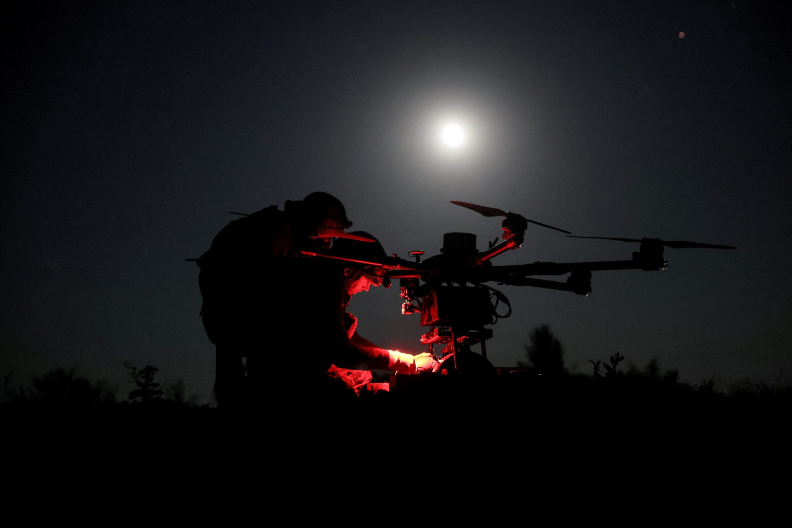 Ukrainian servicemen prepare a heavy combat drone before flying it over positions of Russian troops near the frontline town of Chasiv Yar