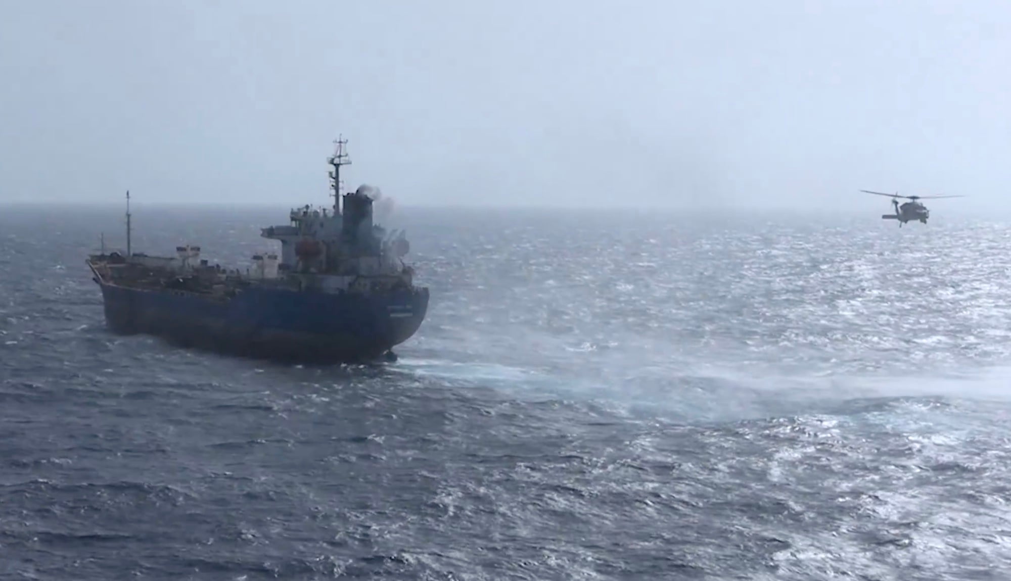 Iranian-flagged oil tanker M/T Celestial Sea in the Gulf of Oman with a U.S. military helicopter flying nearby during a U.S. blockade enforcement operation.