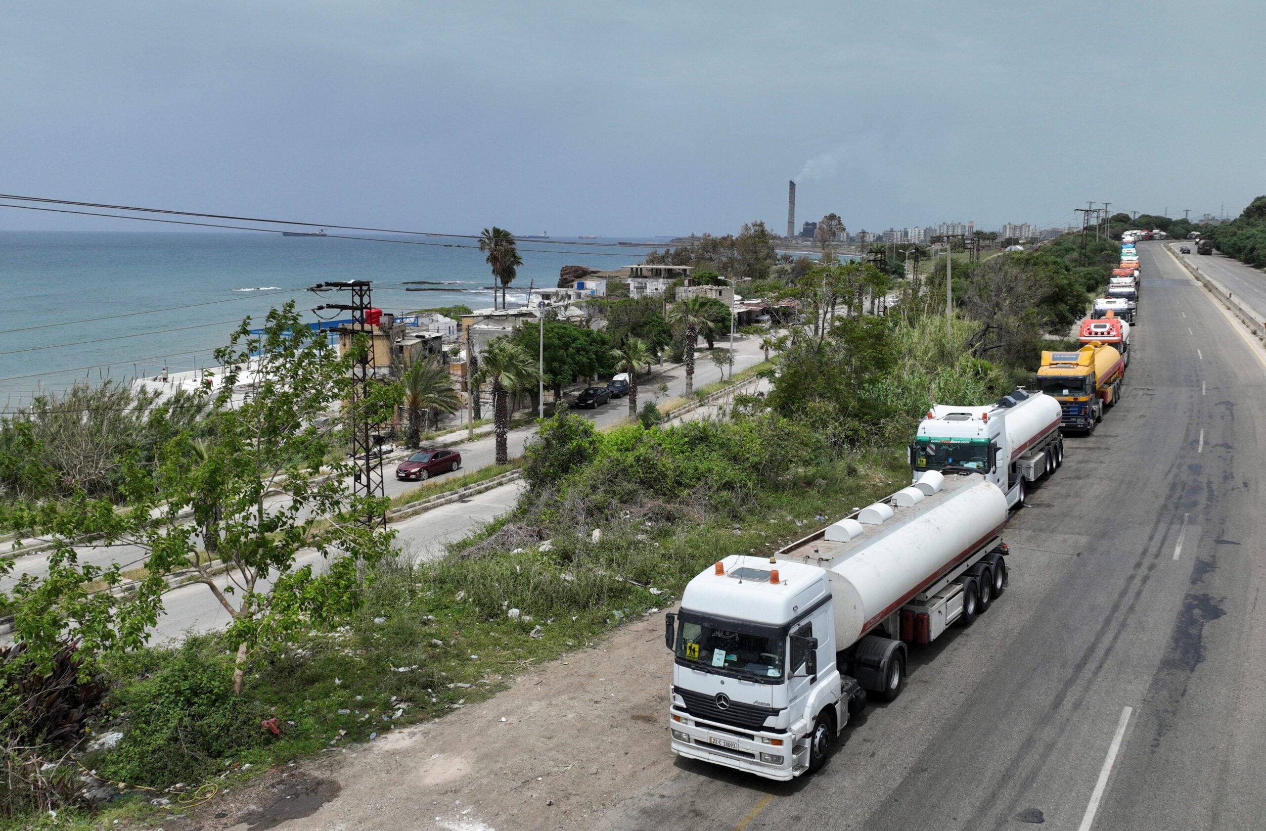 A drone view shows oil trucks arriving from Iraq on their way to the Baniyas oil terminal
