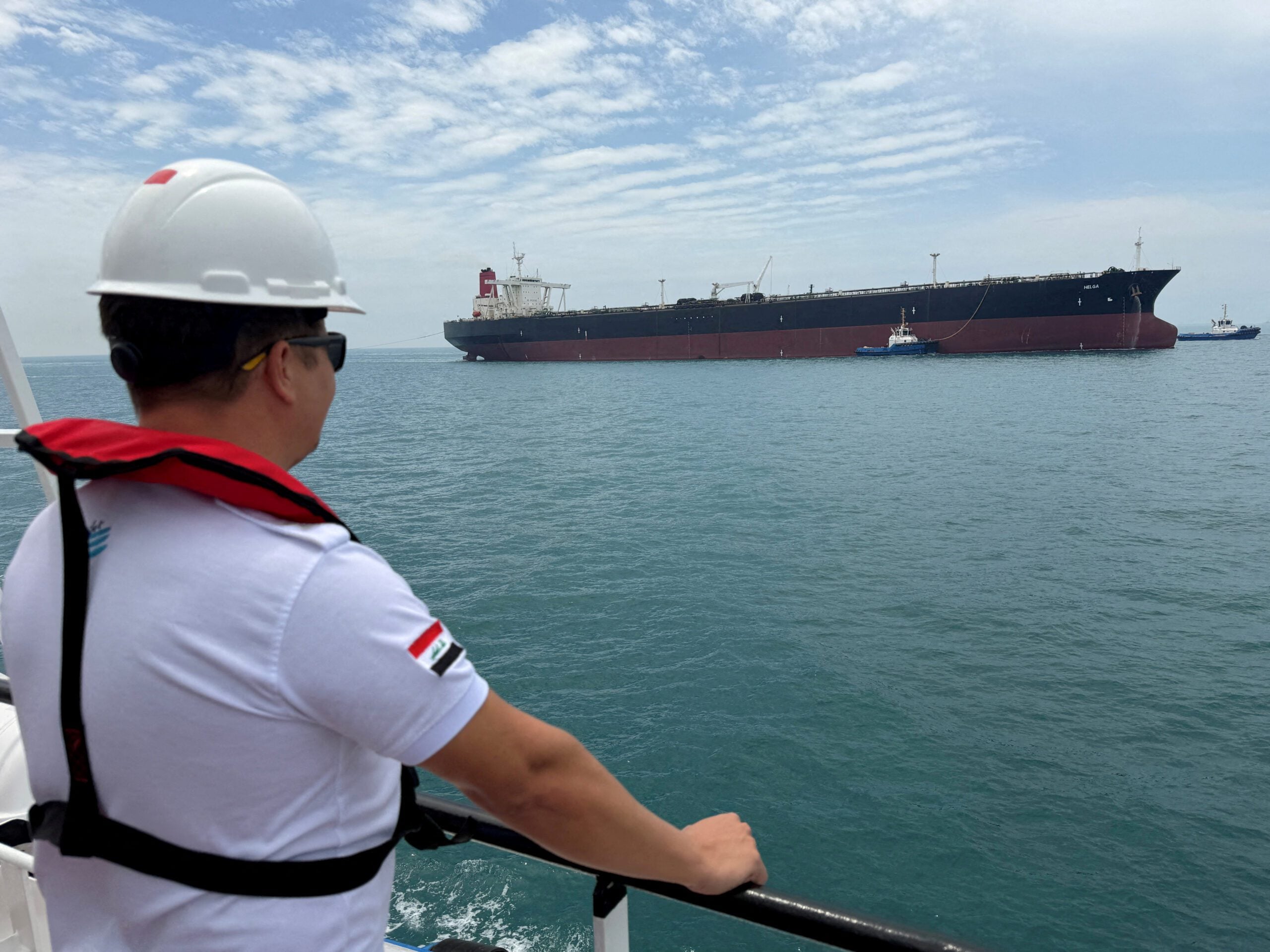 A sailor observes the oil tanker HELGA