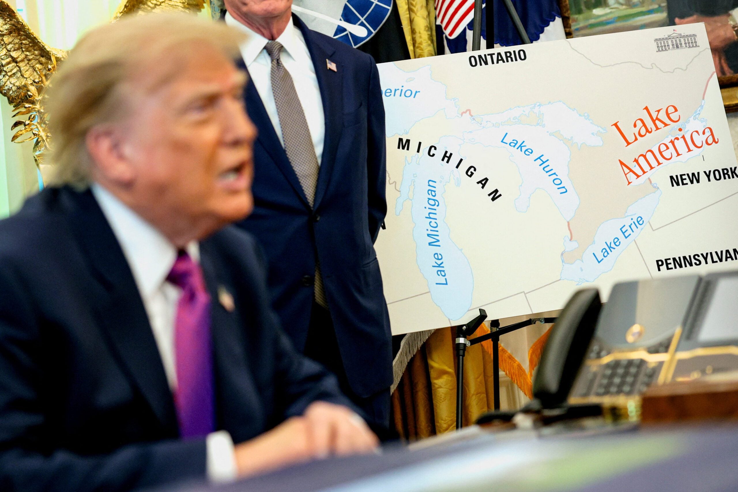 U.S. President Donald Trump speaks next to a map with "Lake America" written on it as he attends an event to sign an executive order renaming Lake Ontario as Lake America at the Oval Office of the White House
