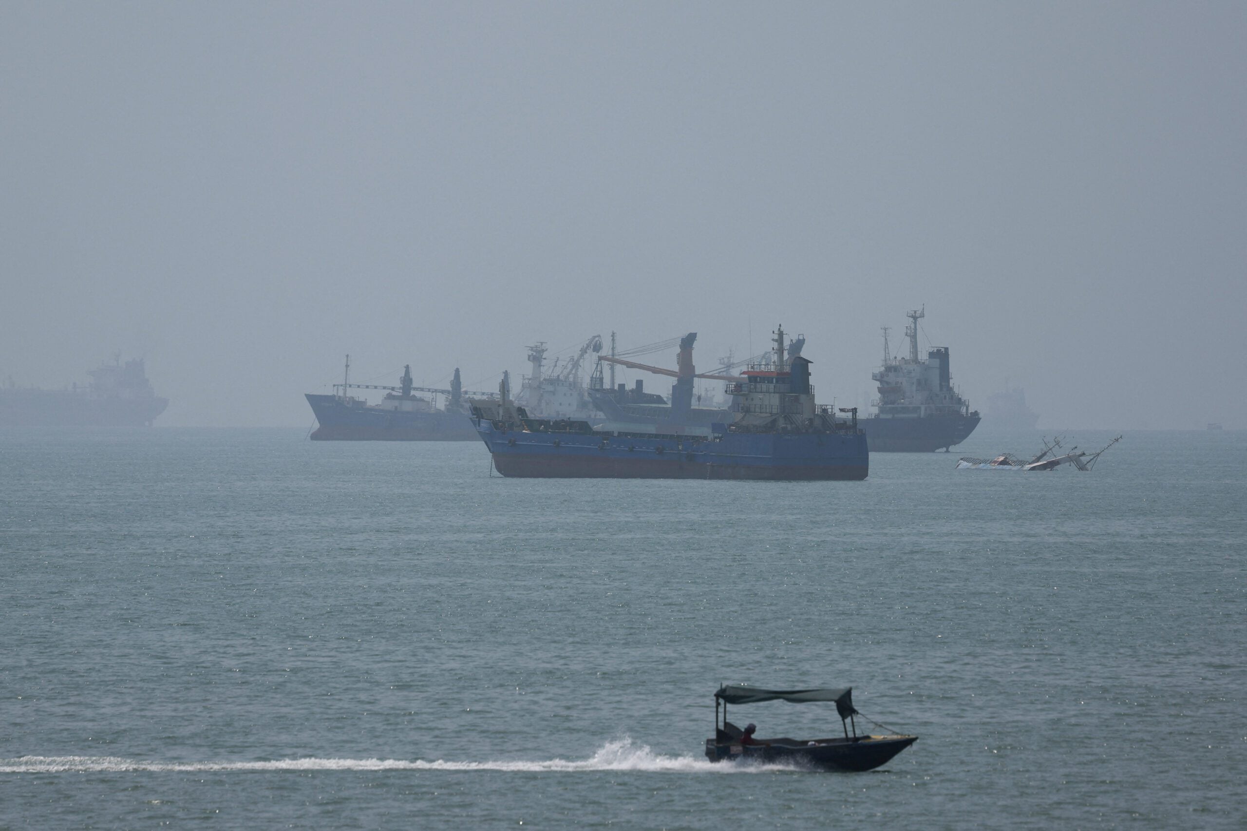 Vessels in the Strait of Hormuz are visible near the beach of Bandar Abbas