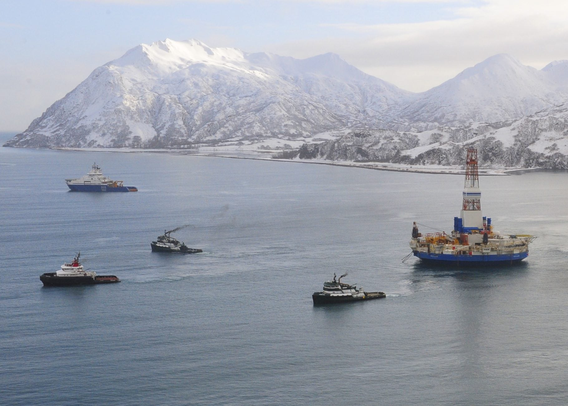 The former Aiviq (blue hull) escorts tugs as they tow the conical drilling unit Kulluk from Kiliuda Bay near Kodiak Island, Alaska, Feb. 26, 2013, following its grounding in late 2012