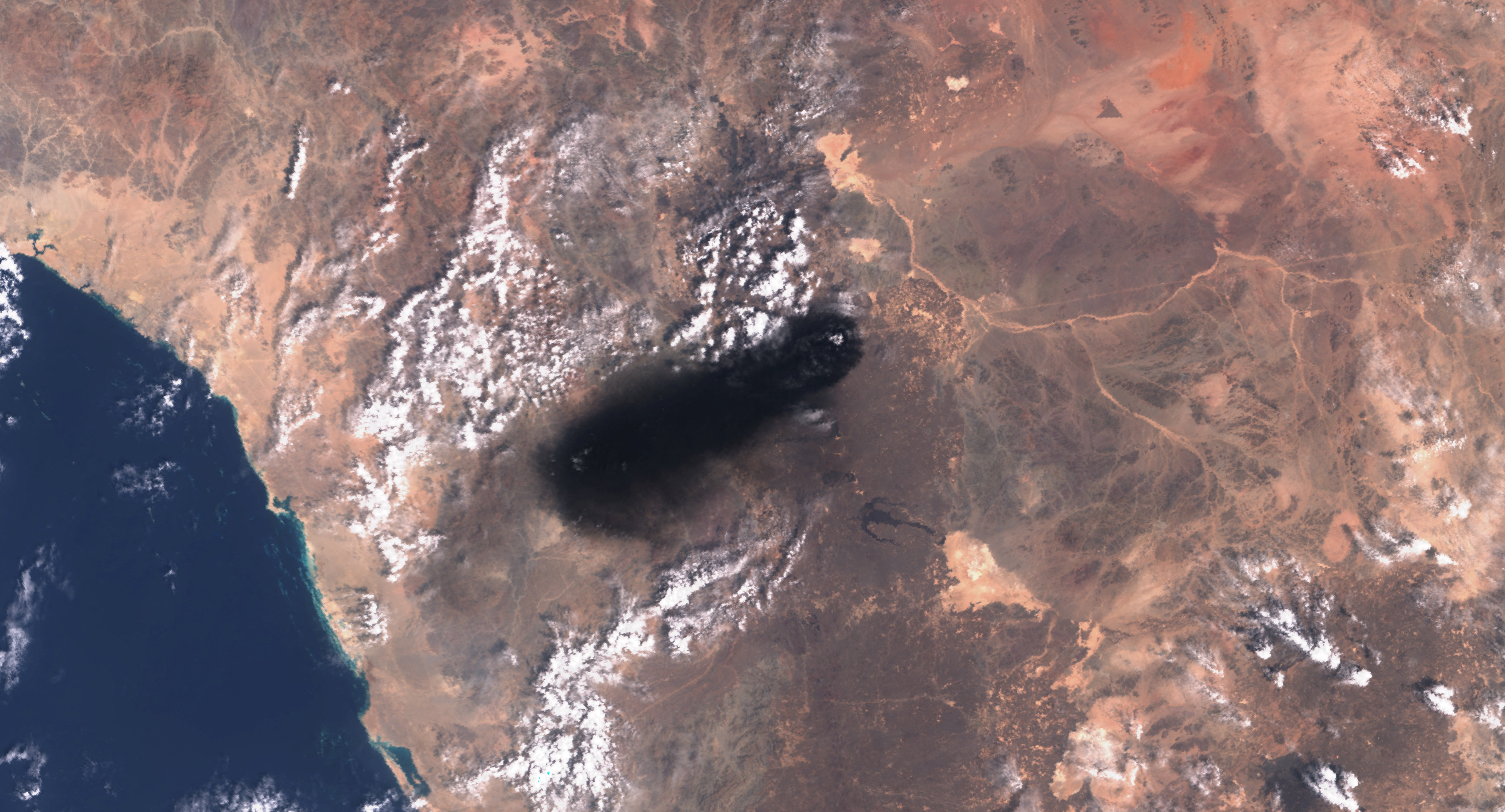 A satellite image shows black smoke rising from an area of Saudi Arabia’s East-West oil pipeline south of Medina