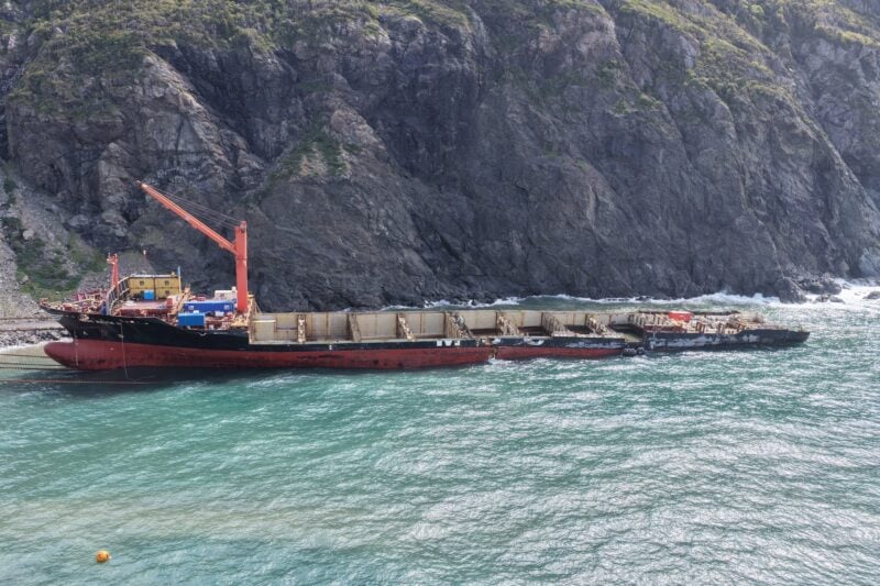 Partially dismantled containership MSC Baltic III sits along the rocky Newfoundland shoreline during ongoing wreck removal operations.