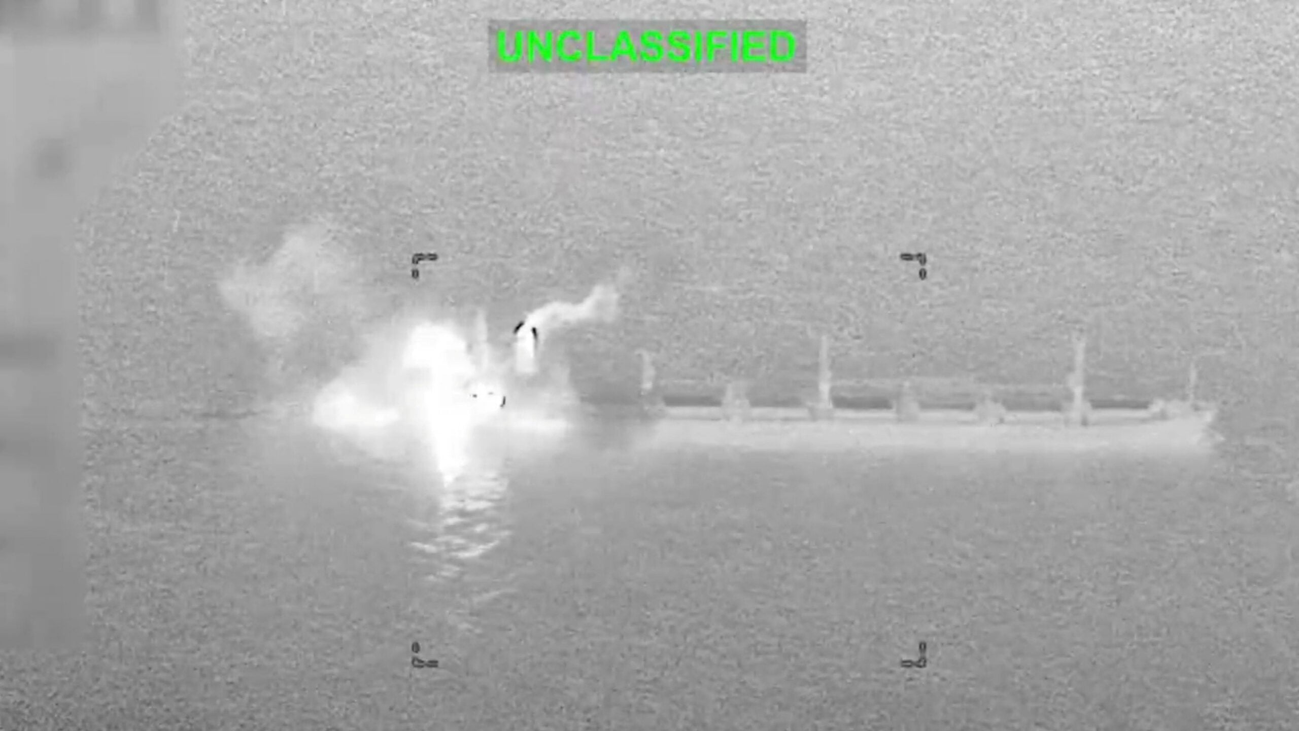 Smoke and fire rise from a commercial cargo vessel following a strike following a US military strike in a location given as the Gulf of Oman