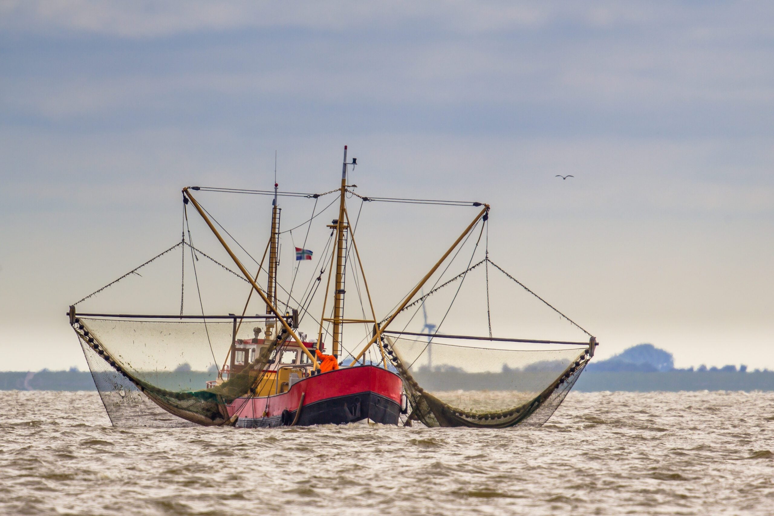 A U.S. fishing boat with nets out on the water.
